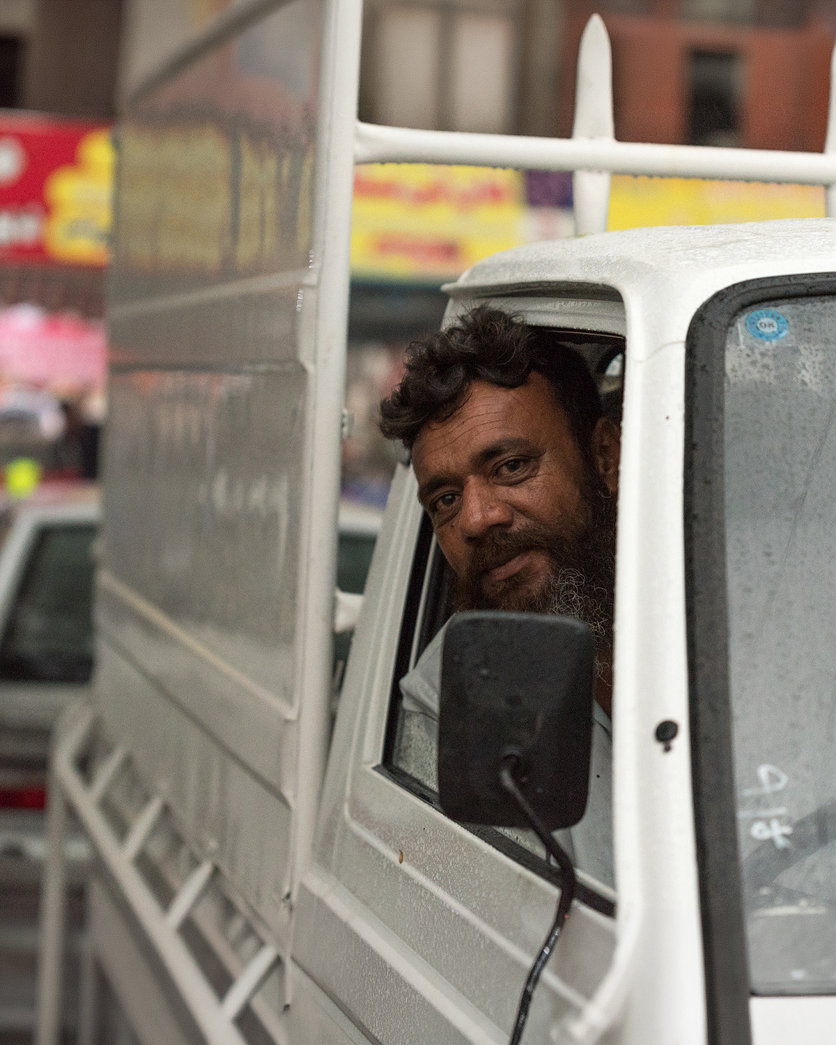 A man sitting in cargo van looking at the camera