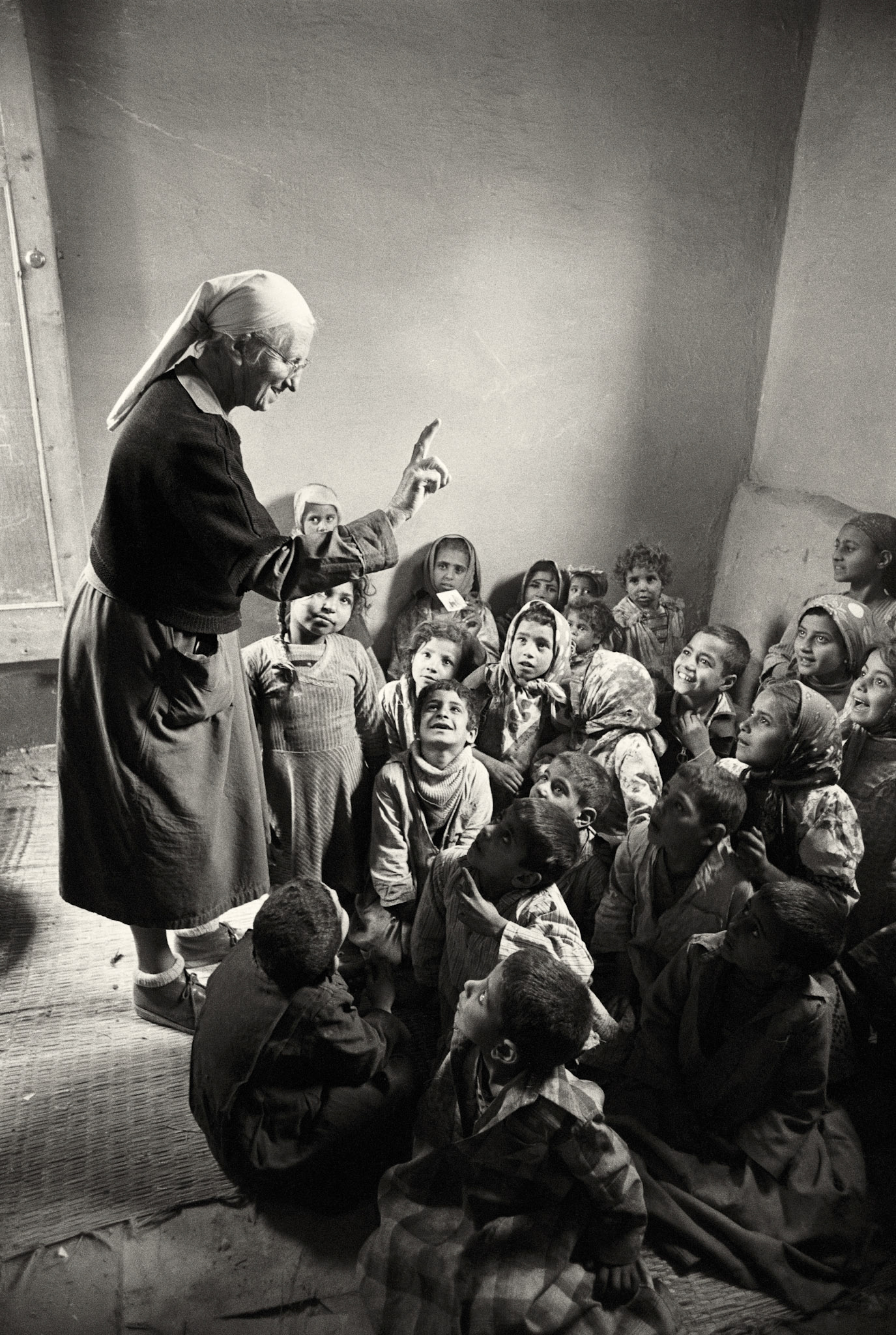 Cairo, Egypt -- April 1982 -- Sister Emmanuelle (Soeur Emmanuelle) teaching poor trash collectors children in the Zabaleen neighborhood of Cairo (1982), where she devoted her life to upgrading their lives from 1971 until 1993 when she went back to France.  After she went back, she was voted France's most favorite woman.  She passed away on 20 October 2008.Photograph by Barry Iverson