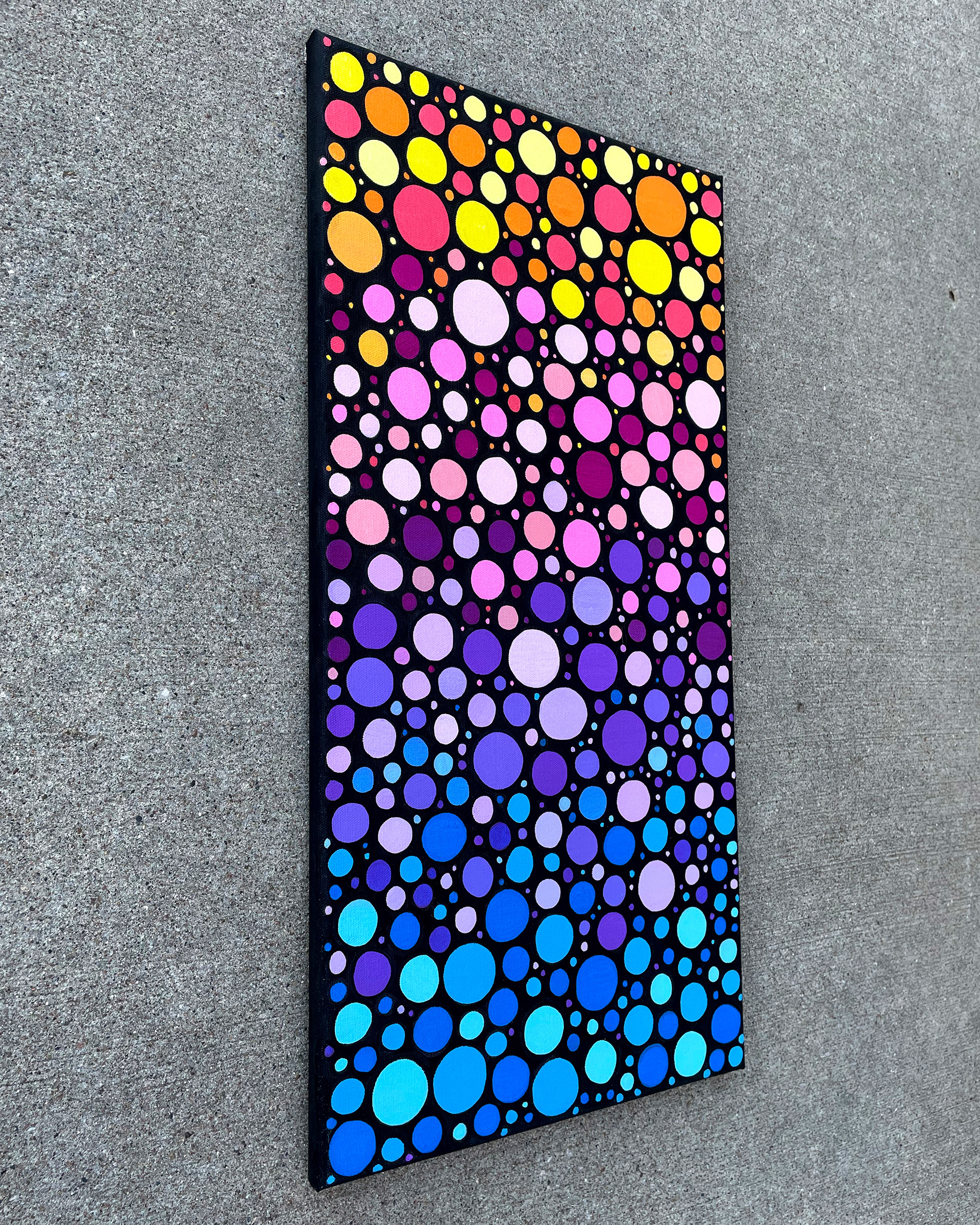 Side of "Sunrise Circles no. 1," Acrylic on canvas. 12 x 24 x 0.5 inches. 2022.