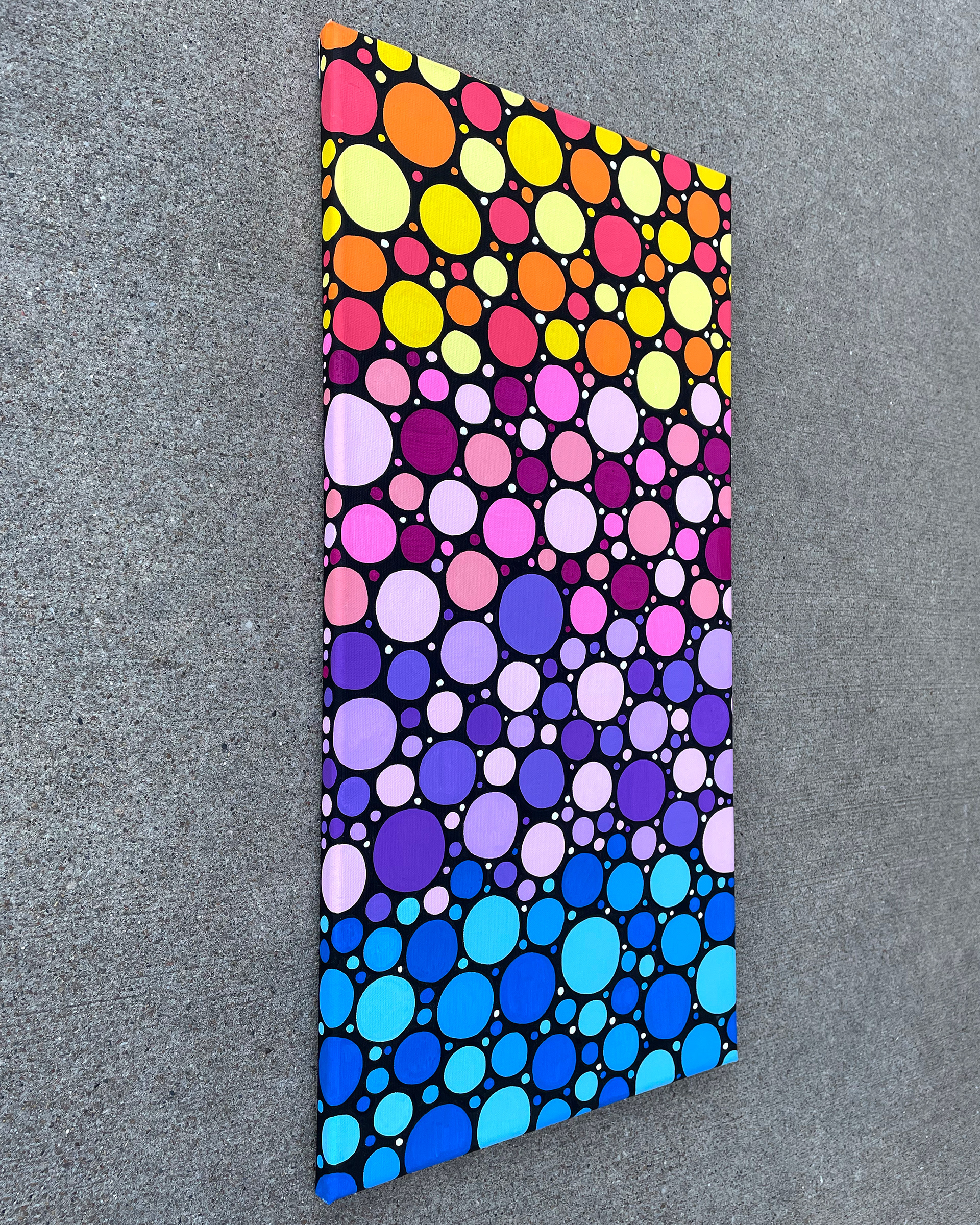 Side of "Sunrise Circles no. 2," Acrylic on canvas. 12 x 24 x 0.5 inches. 2022.