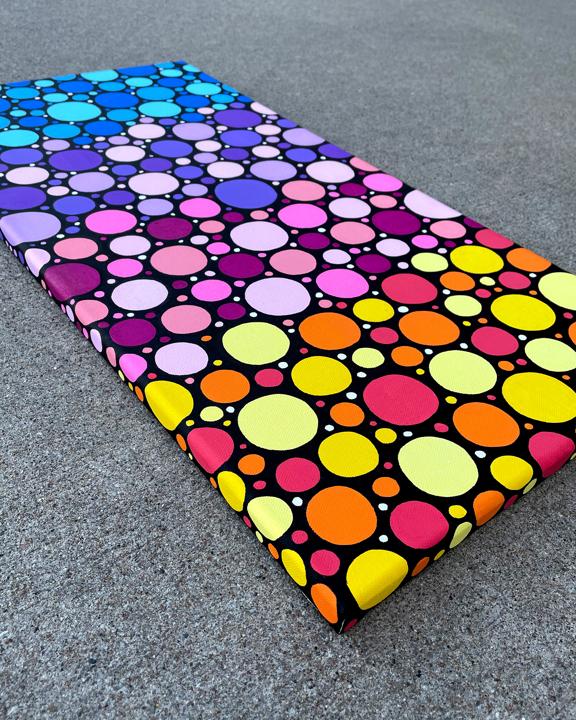Side of "Sunrise Circles no. 2," Acrylic on canvas. 12 x 24 x 0.5 inches. 2022.
