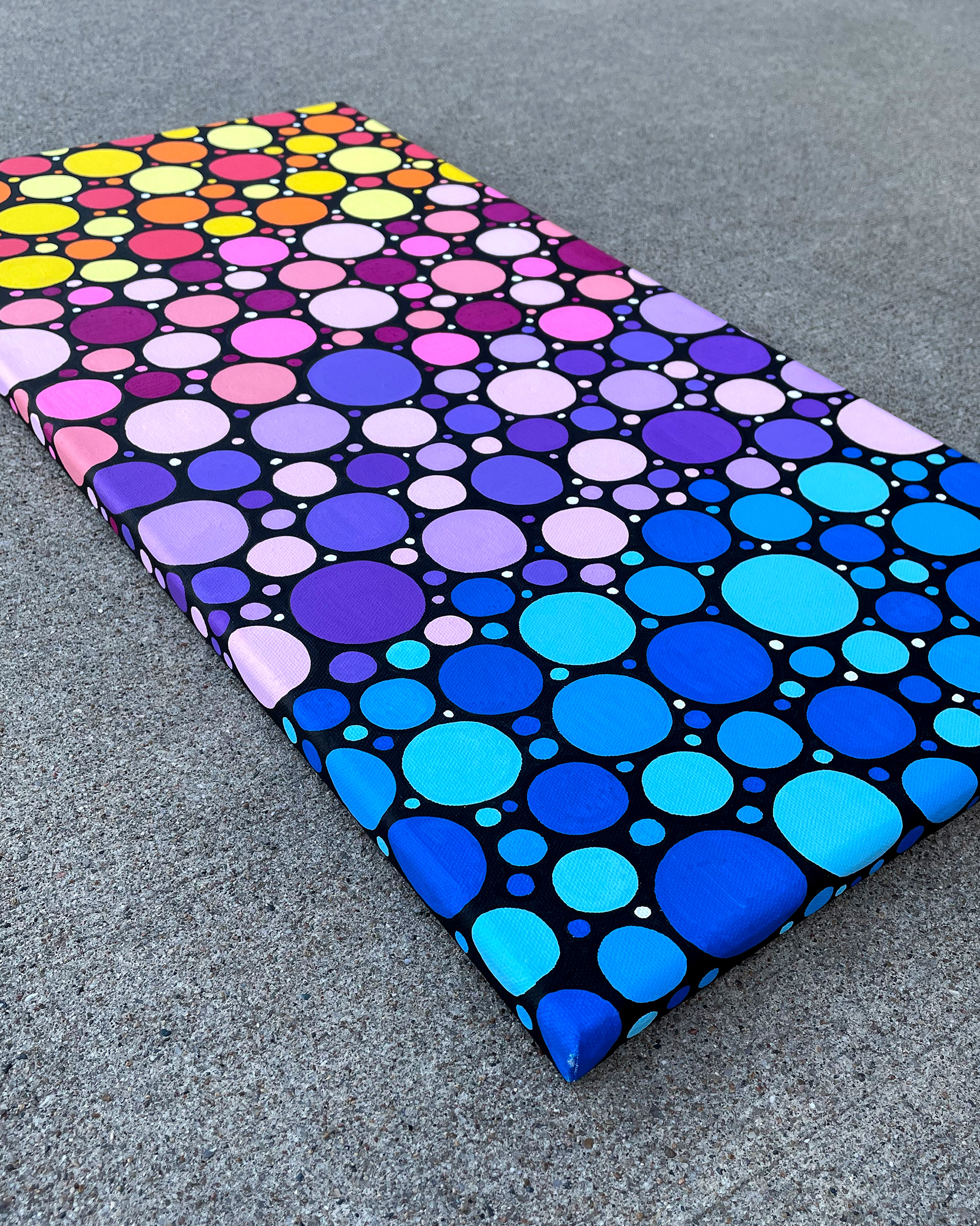 Side of "Sunrise Circles no. 2," Acrylic on canvas. 12 x 24 x 0.5 inches. 2022.