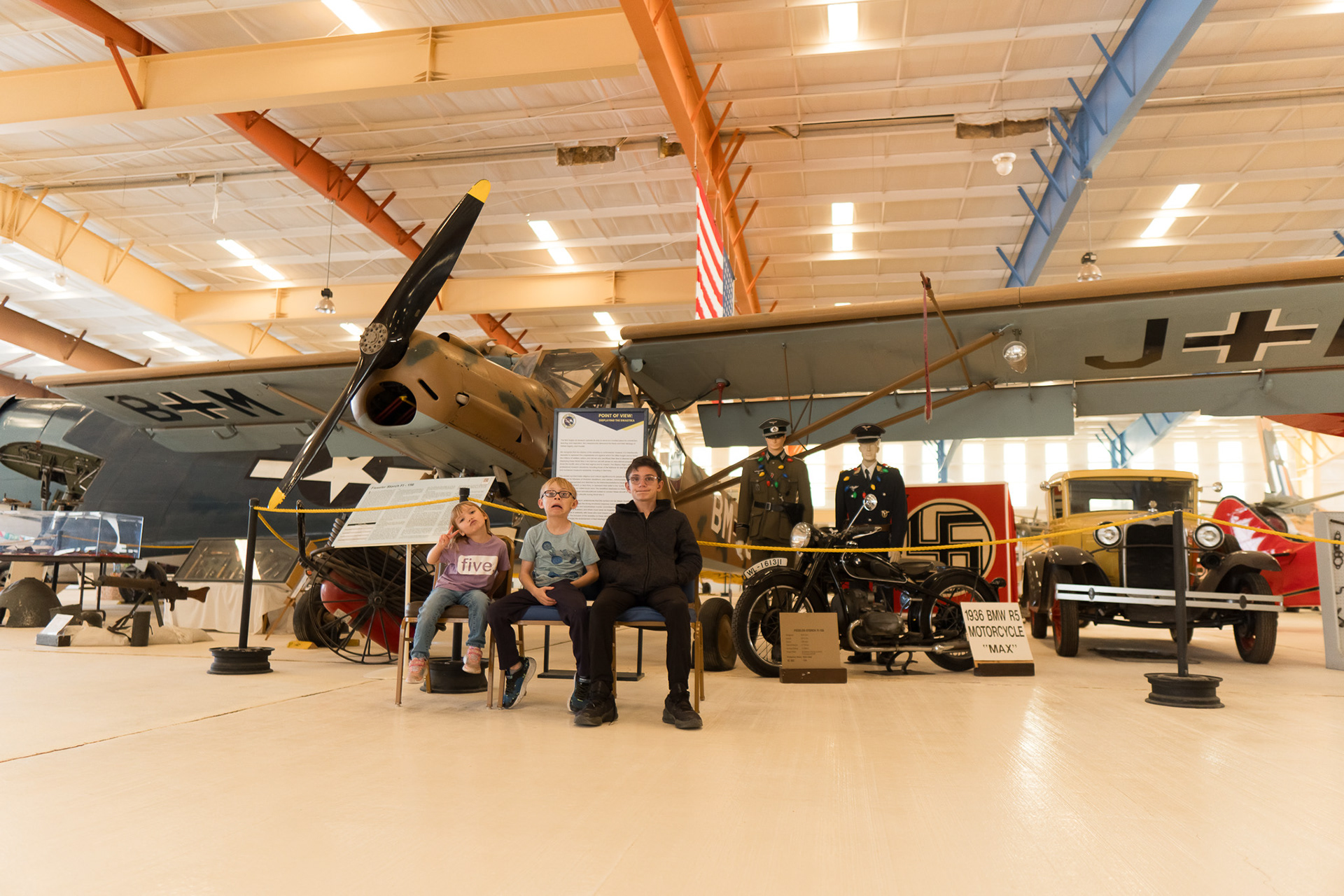 The kids sitting in frontt of a Fieseler FI-156 Storch