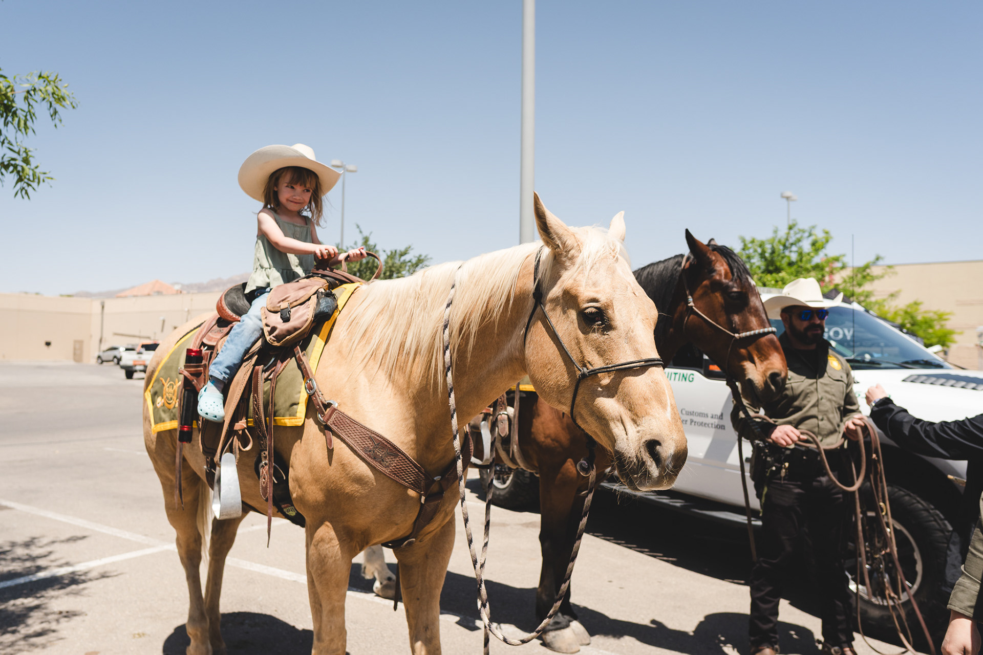 Ella sitting on a Border patrol horse named Trigger