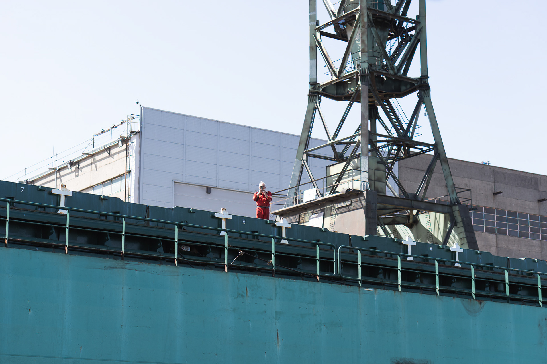 A man on freighter taking our picture as we rode on the Martwa Wisla River in the galeon