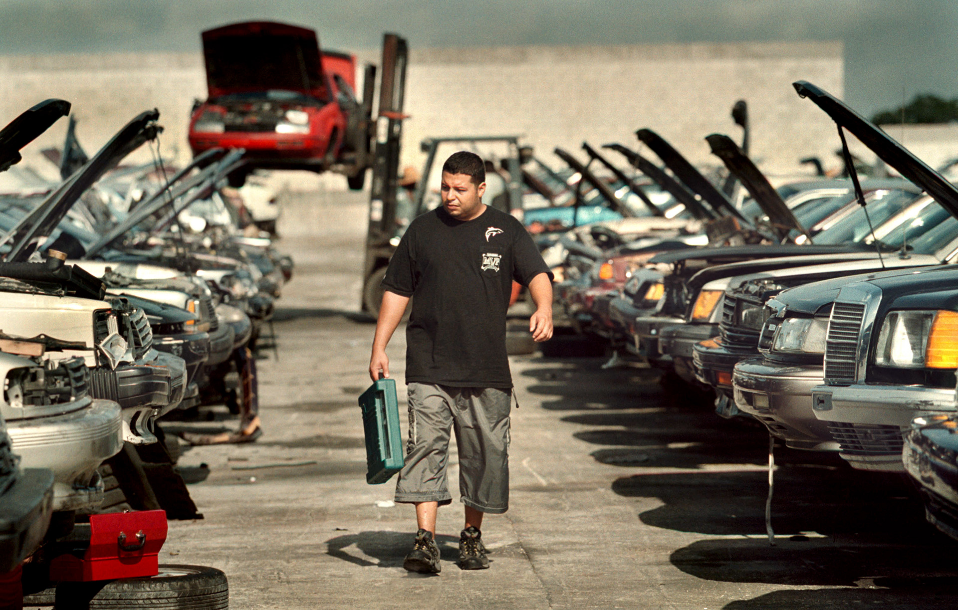 Unable to drive to work, George Feliciano searches junkyard for part to repair his car.
