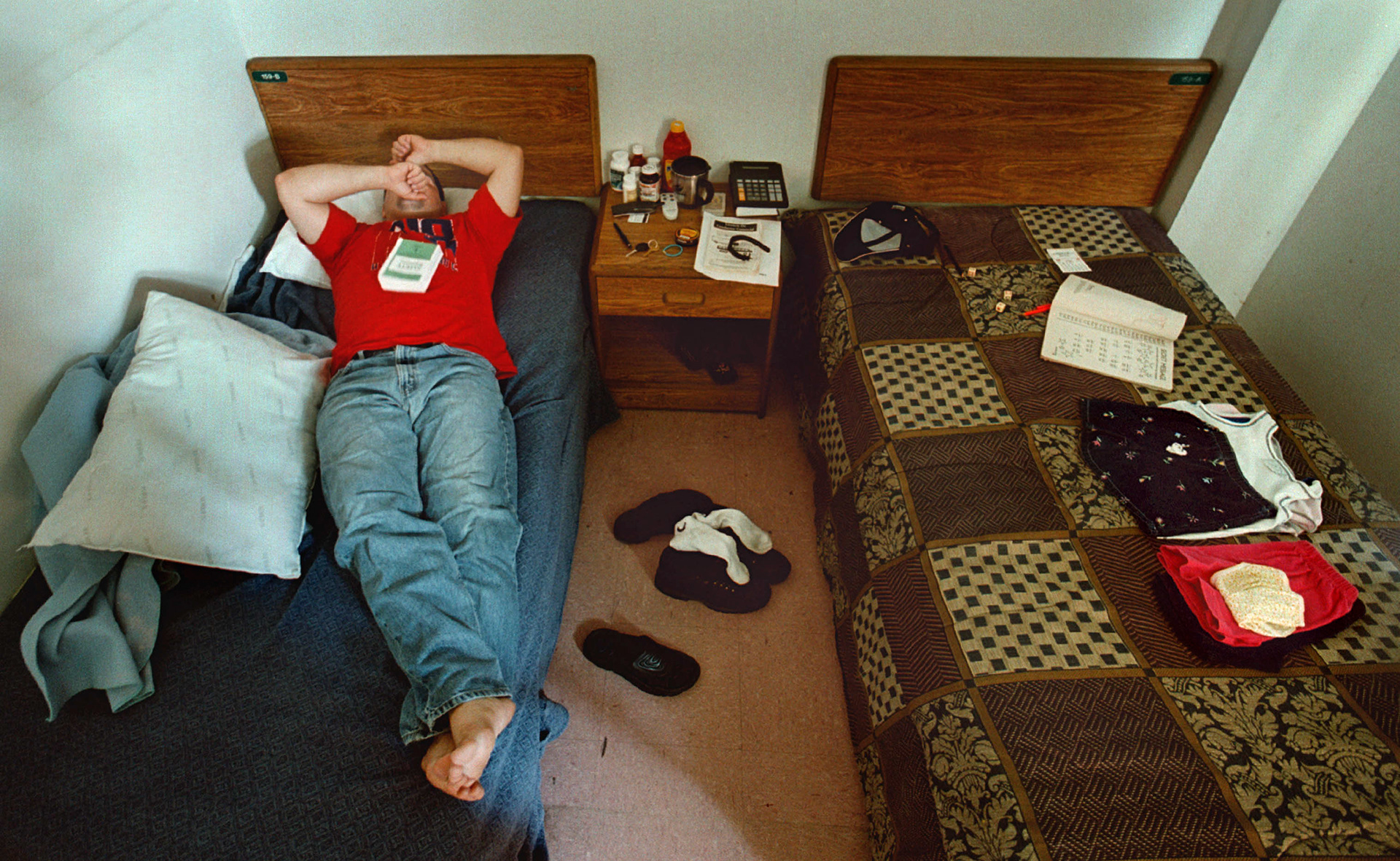 Orlando Valdes lays dejected in homeless shelter after another unsuccessful day of finding work.