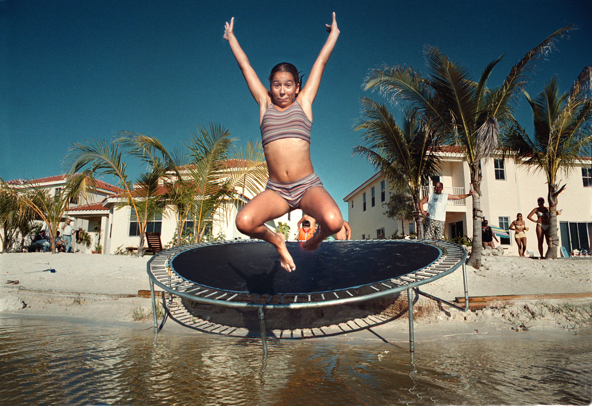 Jaqueline Proctor trampolines into backyard lake.