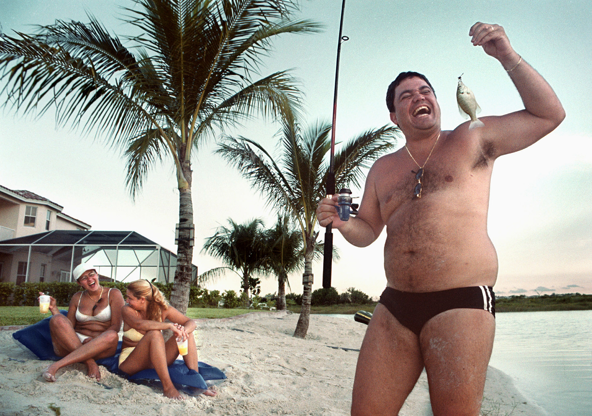 Antonio Martin marvels at the size of his catch from his backyard beach on man-made lake.