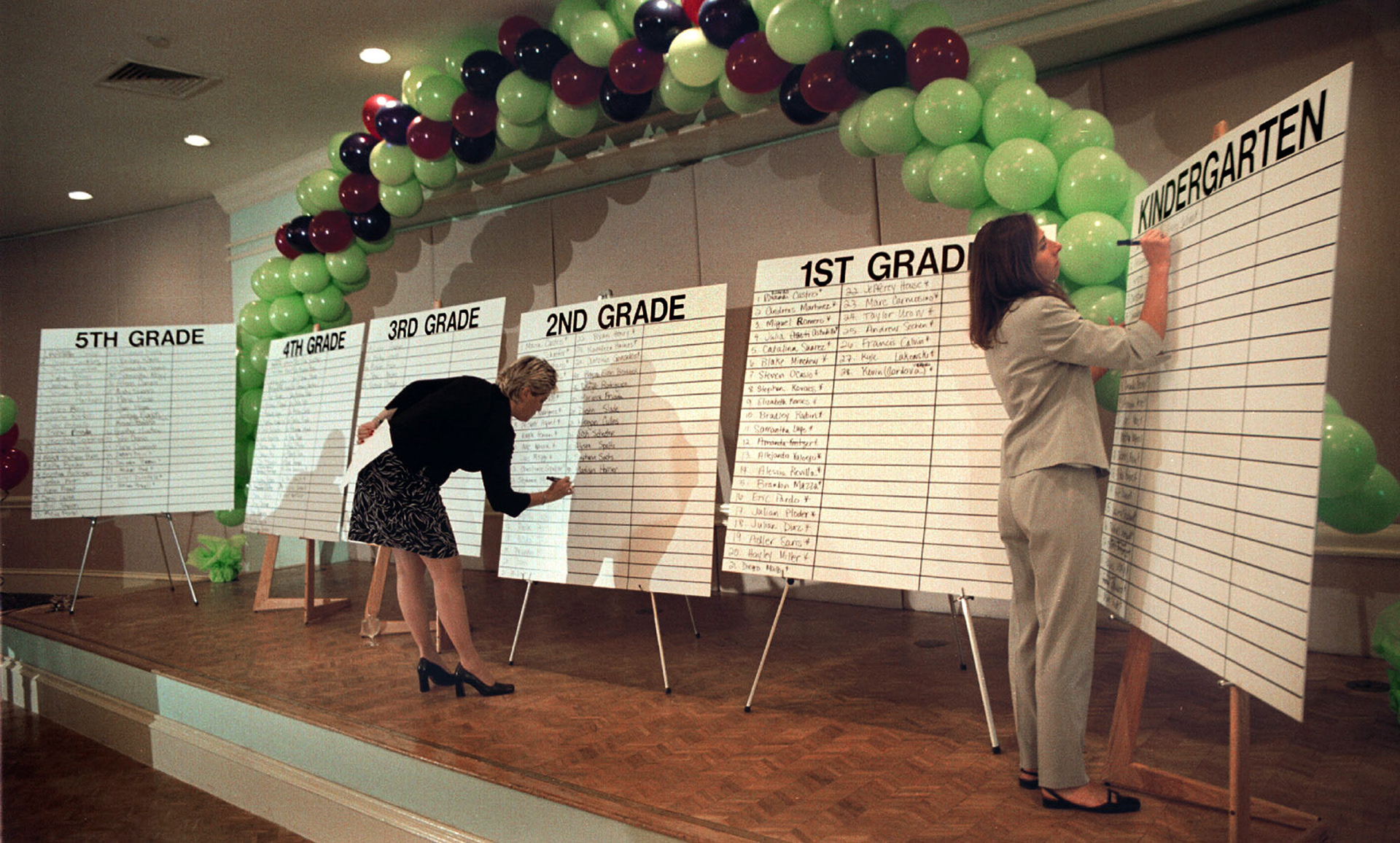 In a game show atmosphere, names of charter school lottery winners are written down.