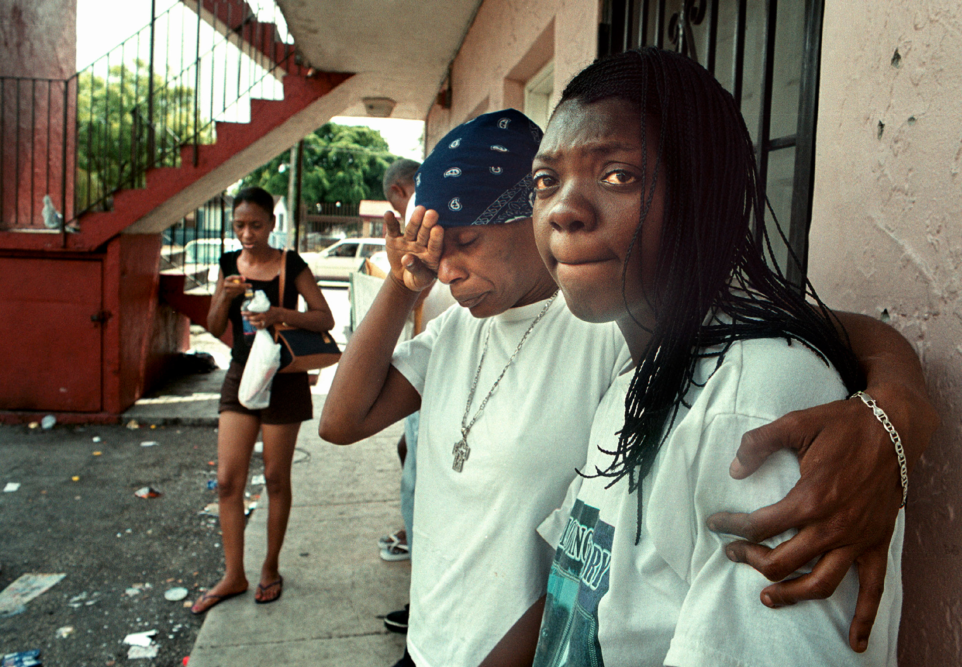  Alanda McMillion, 26, right, gets consoled by Tangela Ingrim after eviction from unsafe building.