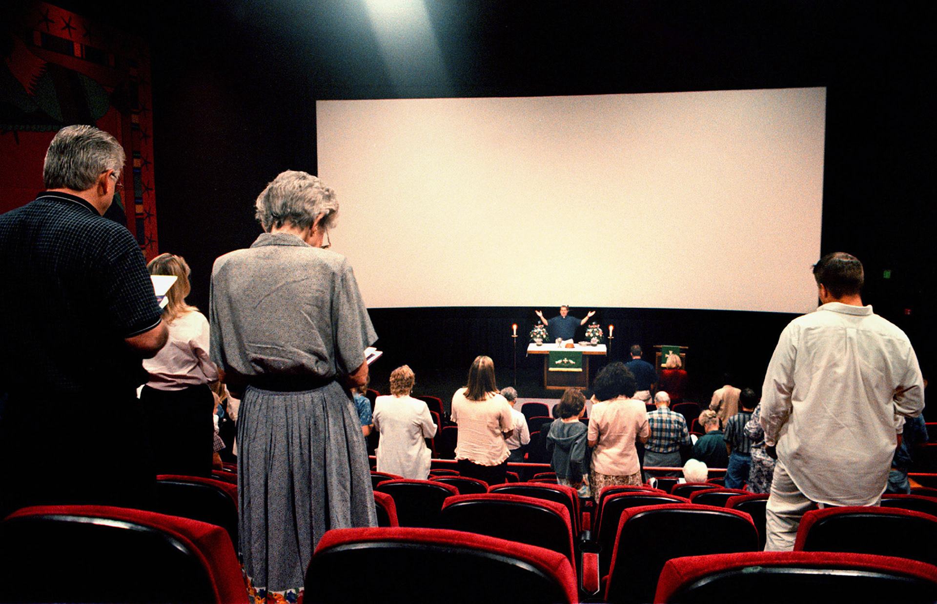 The Living Faith Lutheran Church holds service at movie theater on Sunday morning.