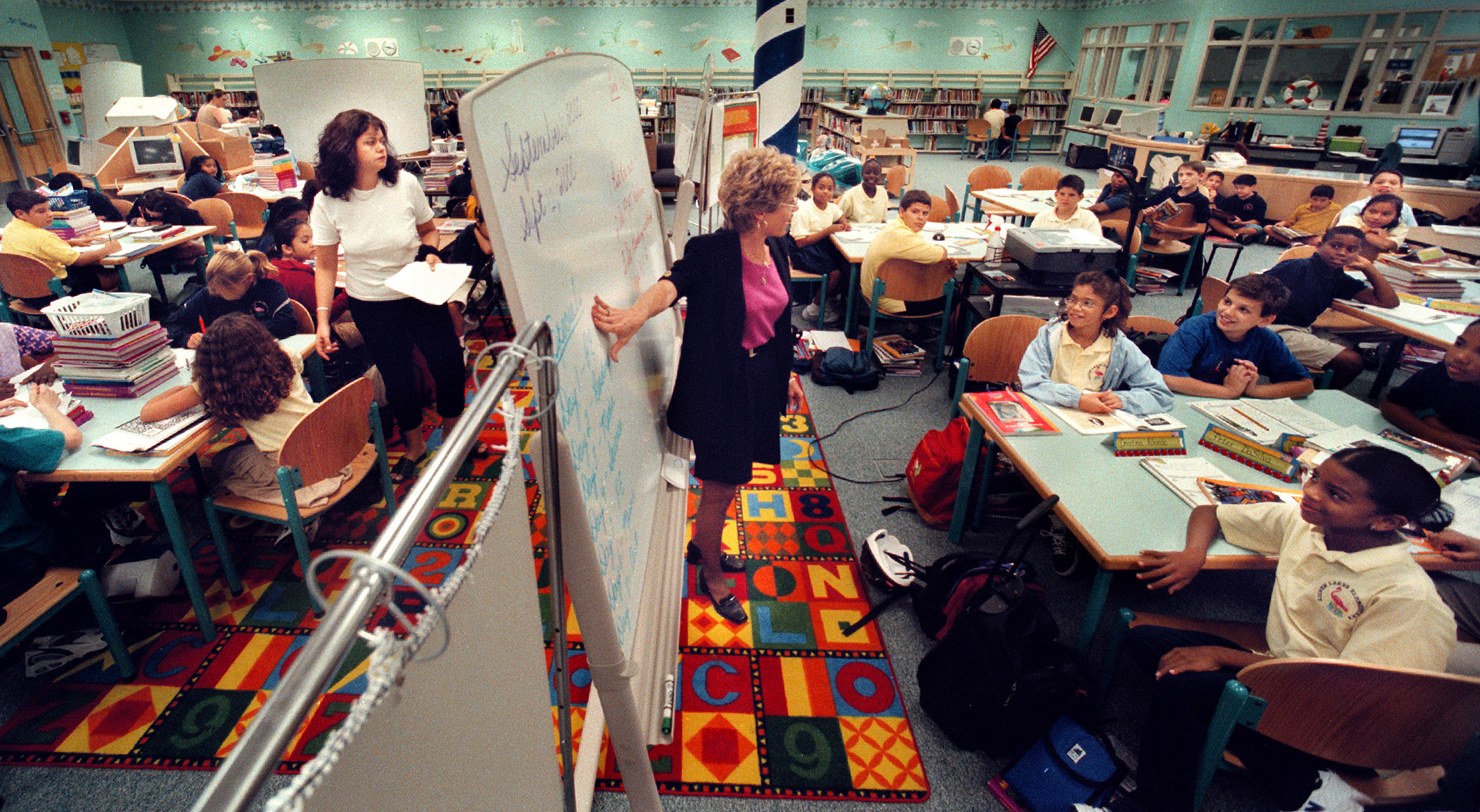 Two fifth-grade class are forced to use library for class at overcrowded school.