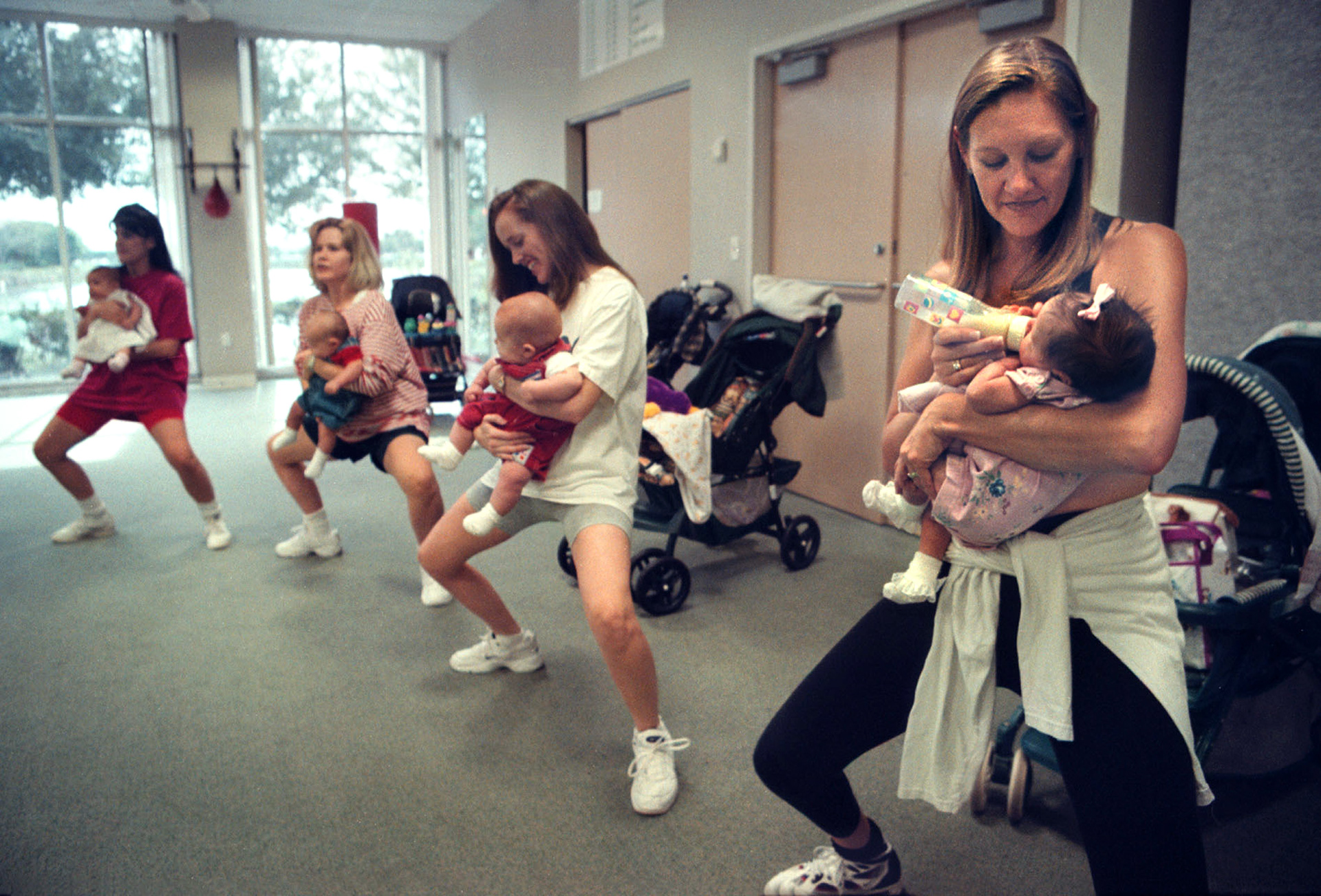 Pam Eskalyo feeds newborn daughter Jaycee during Mommy & Me class.