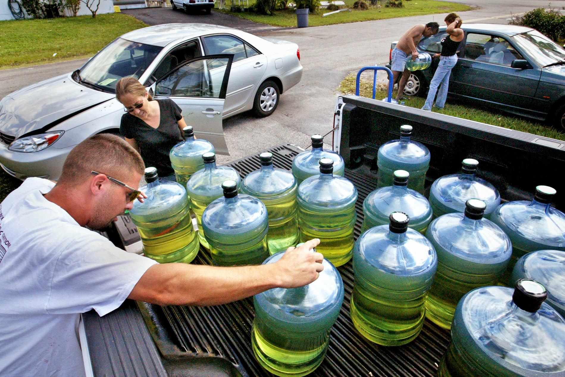 Phil Gray, left, traveled hundreds of miles to bring back 130 gallons of gas to help family and friends.