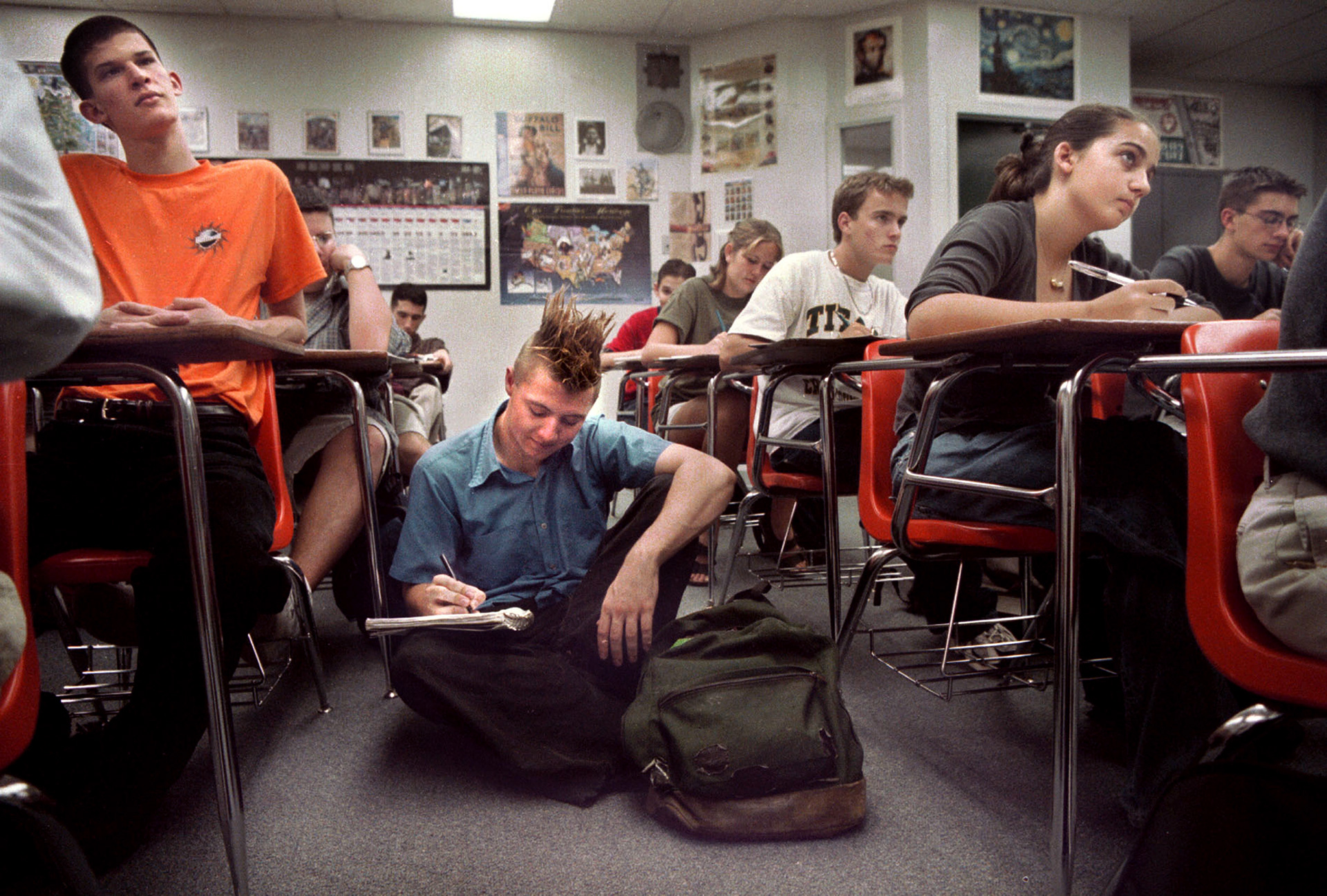 Charlie Flowers resorts to sit on floor in overcrowded history class.