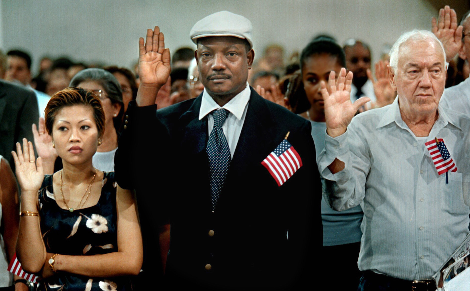 A woman from Laos, a man from Trinidad, a man from Cuba get sworn-in as American citizens. 
