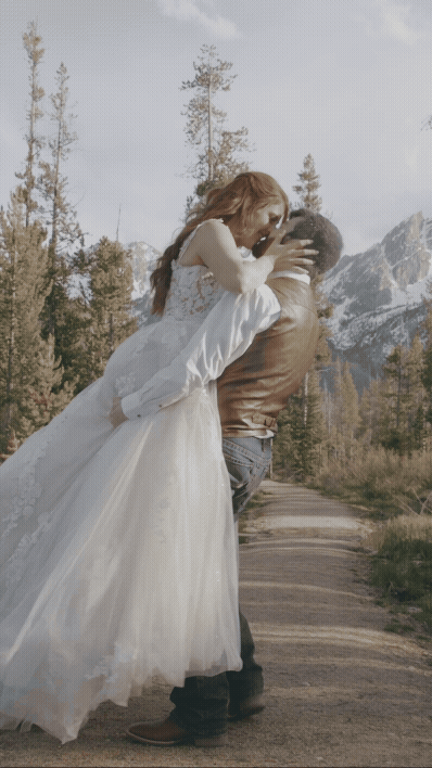 A newlywed couple embracing on a stunning mountaintop during their Lake Tahoe elopement, captured by Northern California wedding videographer Nopalii Film