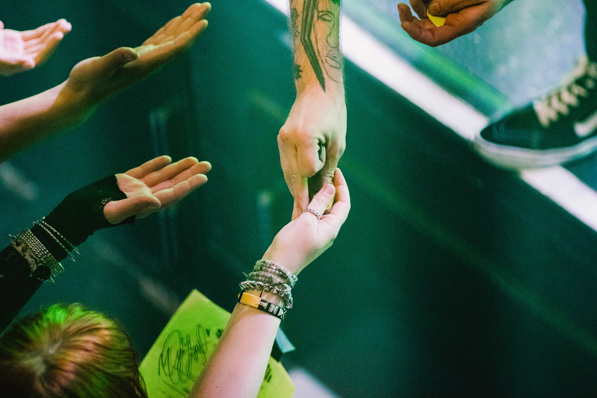 Fan receives guitar pick at the end of Sweet Pill's set
