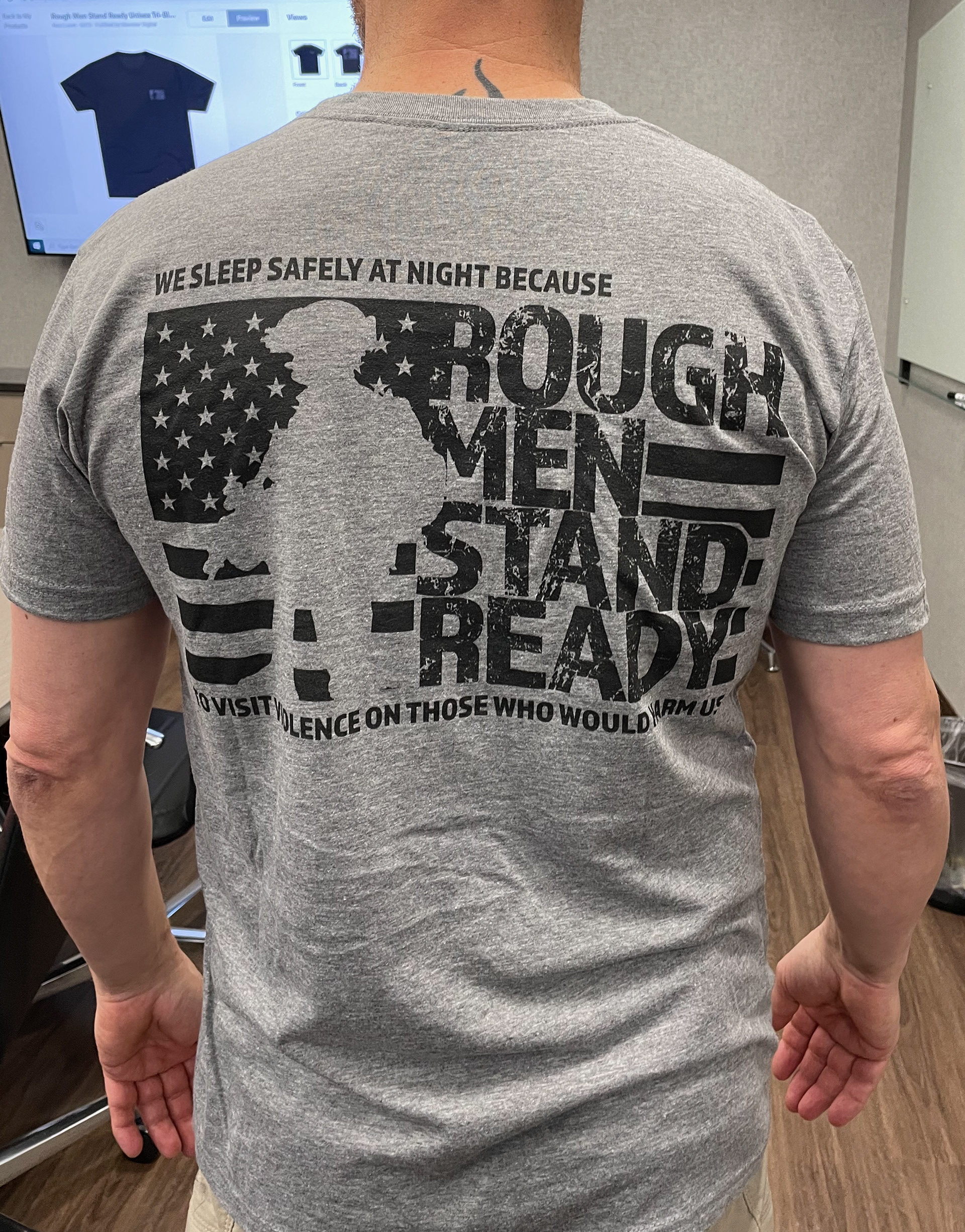 Rough Men Stand Ready T-shirt sample being evaluated and modeled by Point One staff member