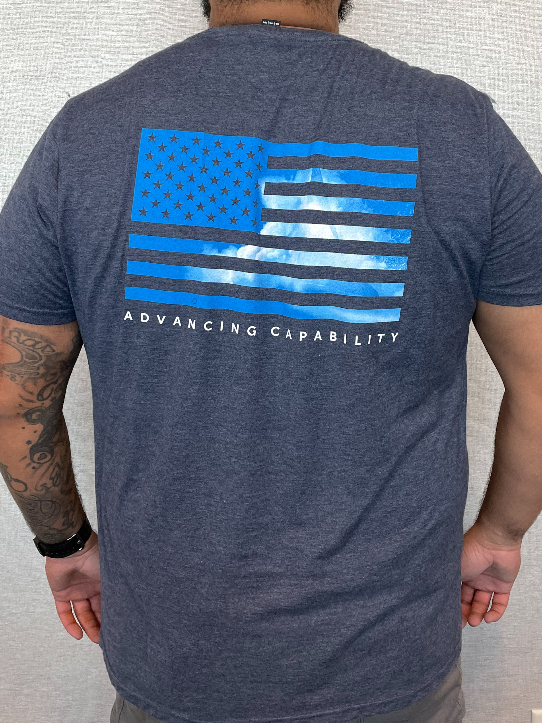 Point One Team member uniform piece, a t-shirt, showing the "Point One explosion" image I photographed and assembled into a rich brand image, and sitting inside the one-color flag on the back of the shirt