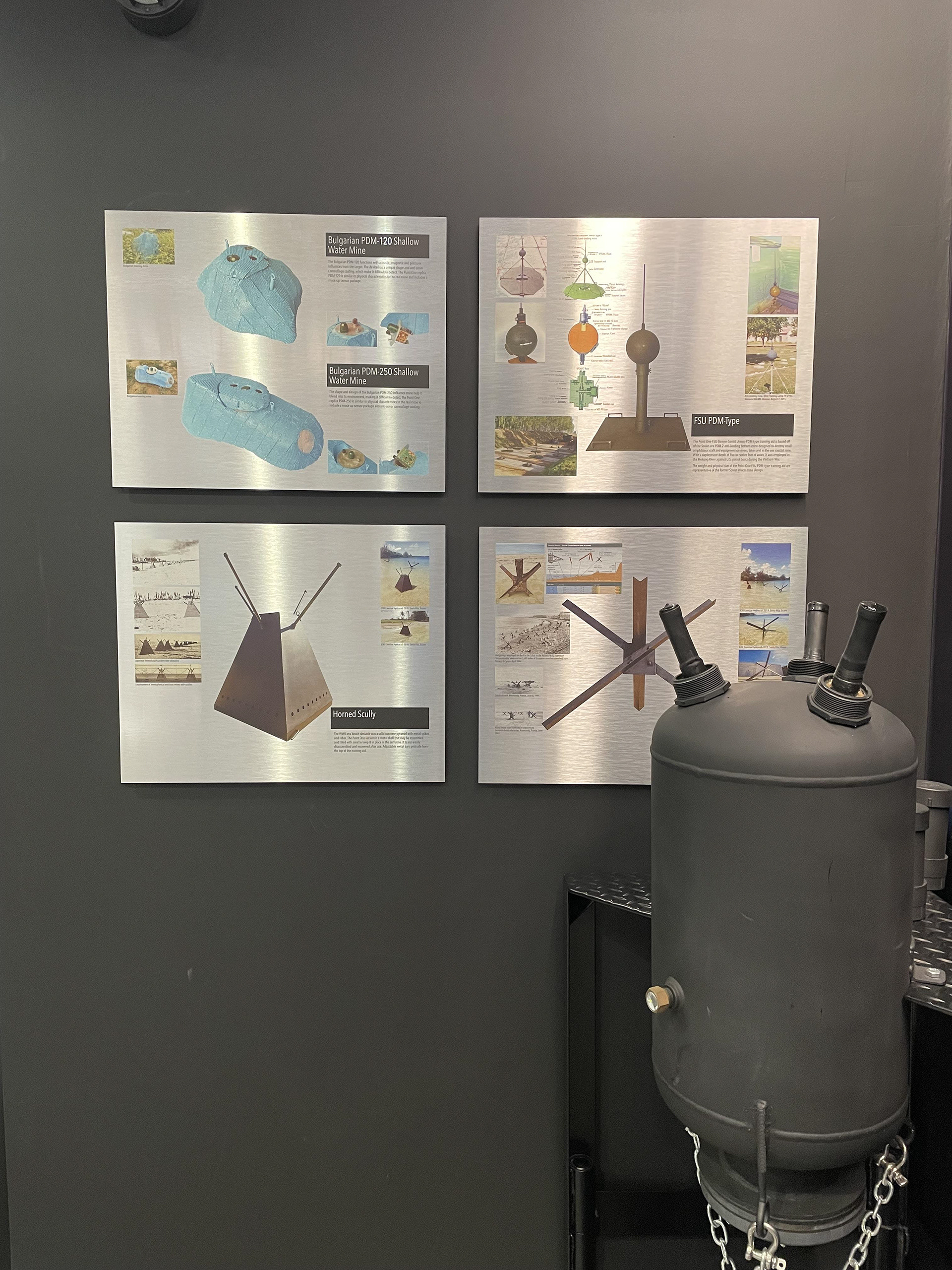Showroom wall art on metal of underwater training devices and beach obstacles