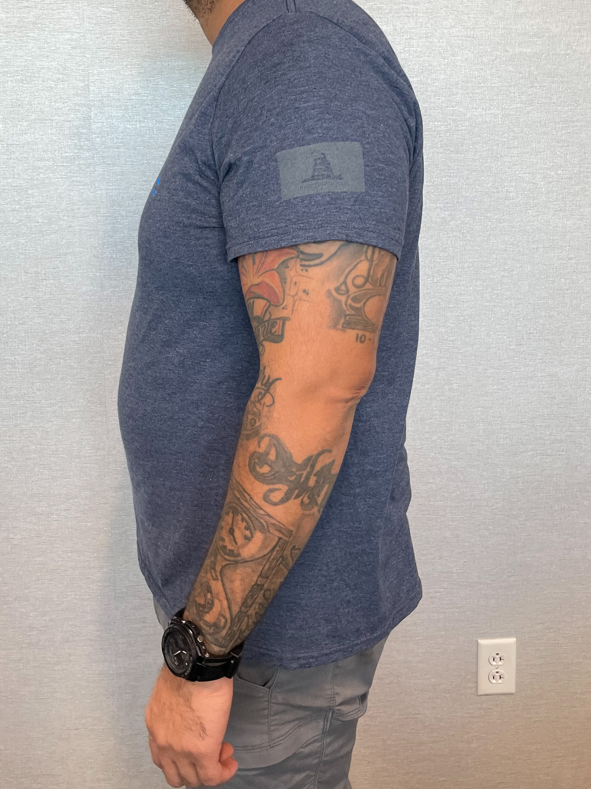 Point One Team member uniform piece, a t-shirt, front displaying the Gadsden flag in one color, on left sleeve