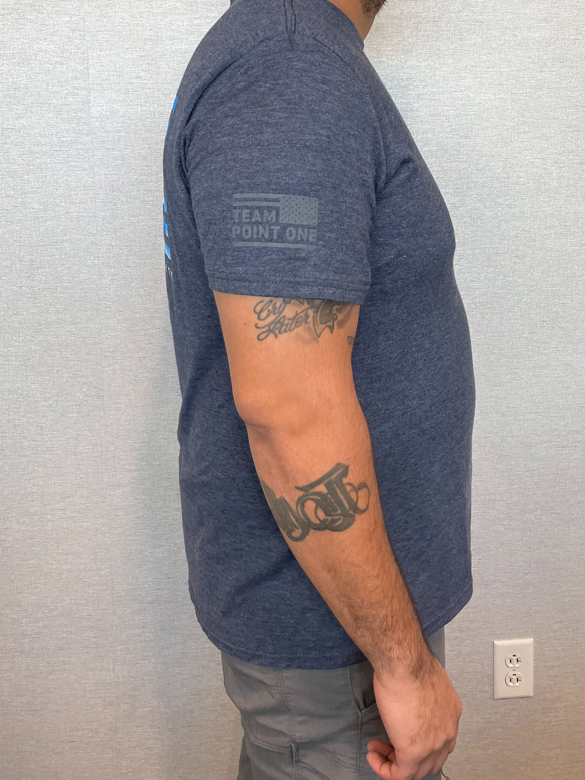 Point One Team member uniform piece, a t-shirt, displaying the Team Point One emblem in one color on the right sleeve