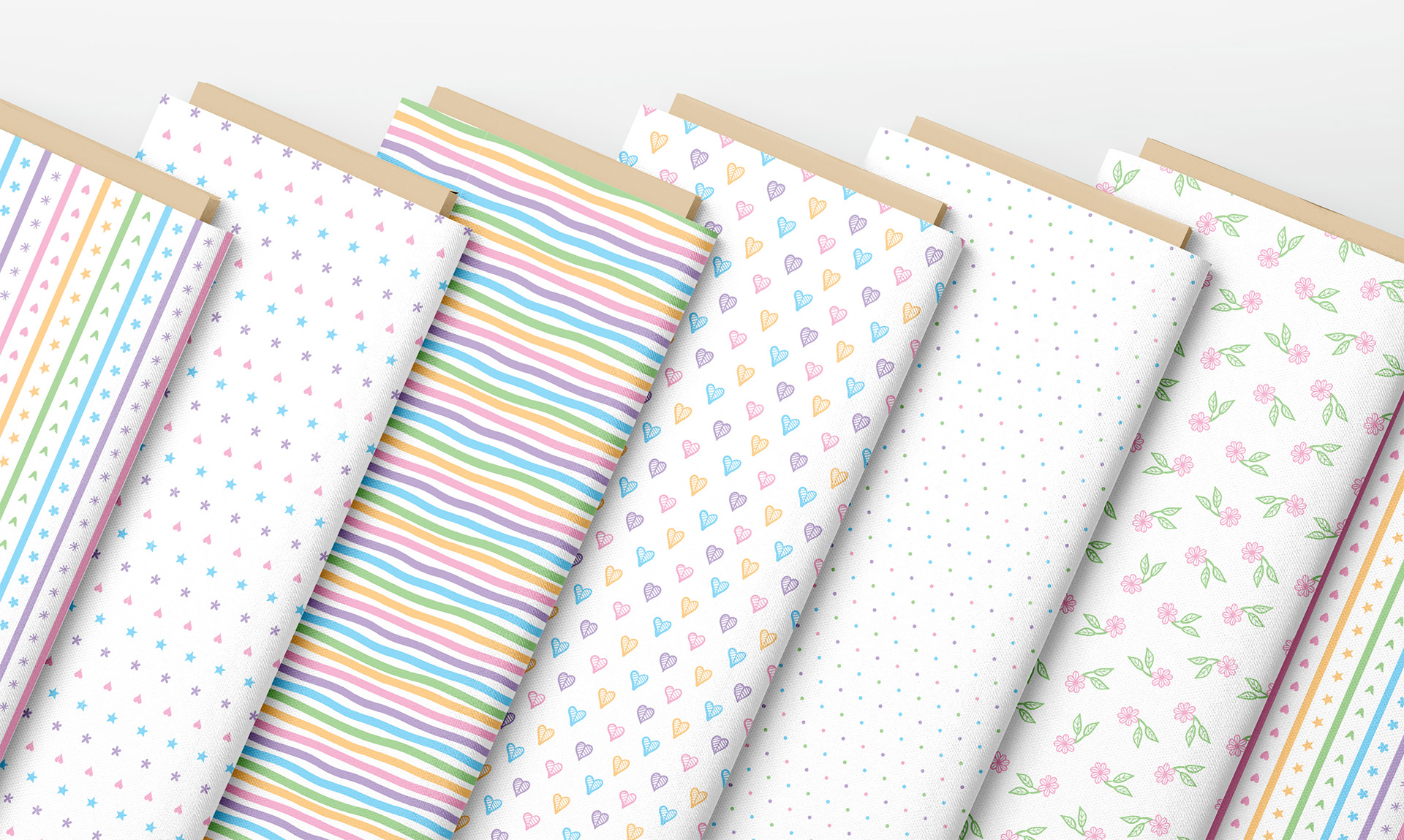 Minimalist patterns in pastel colors applied to fabric, featuring stripes, hearts, dots, flowers, and stars