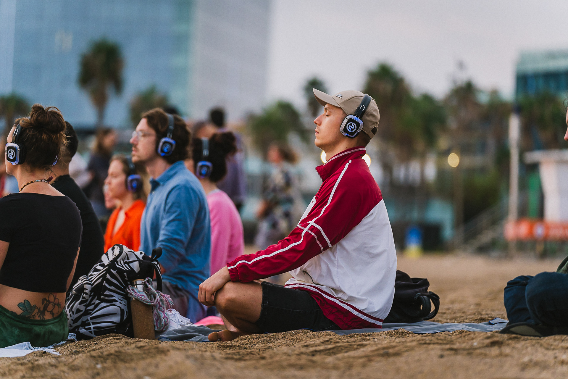 Meditative outdoor yoga event in Barcelona captured at golden hour, highlighting peaceful group poses and natural scenery