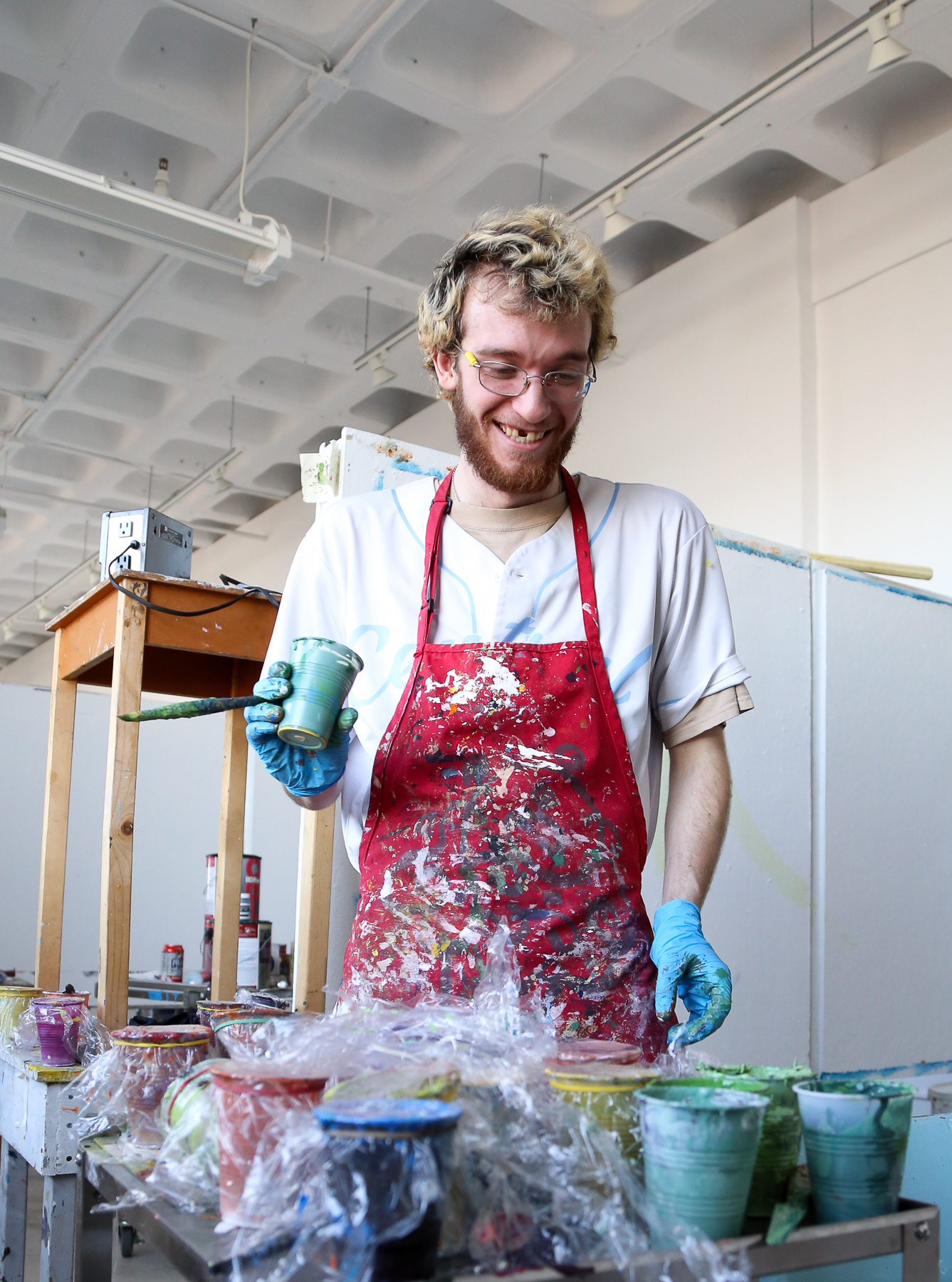 Portrait of Stephen Barratt mixing oil paints while working on a painting in his studio at Boston University's College of Fine Arts; March 4th, 2025.