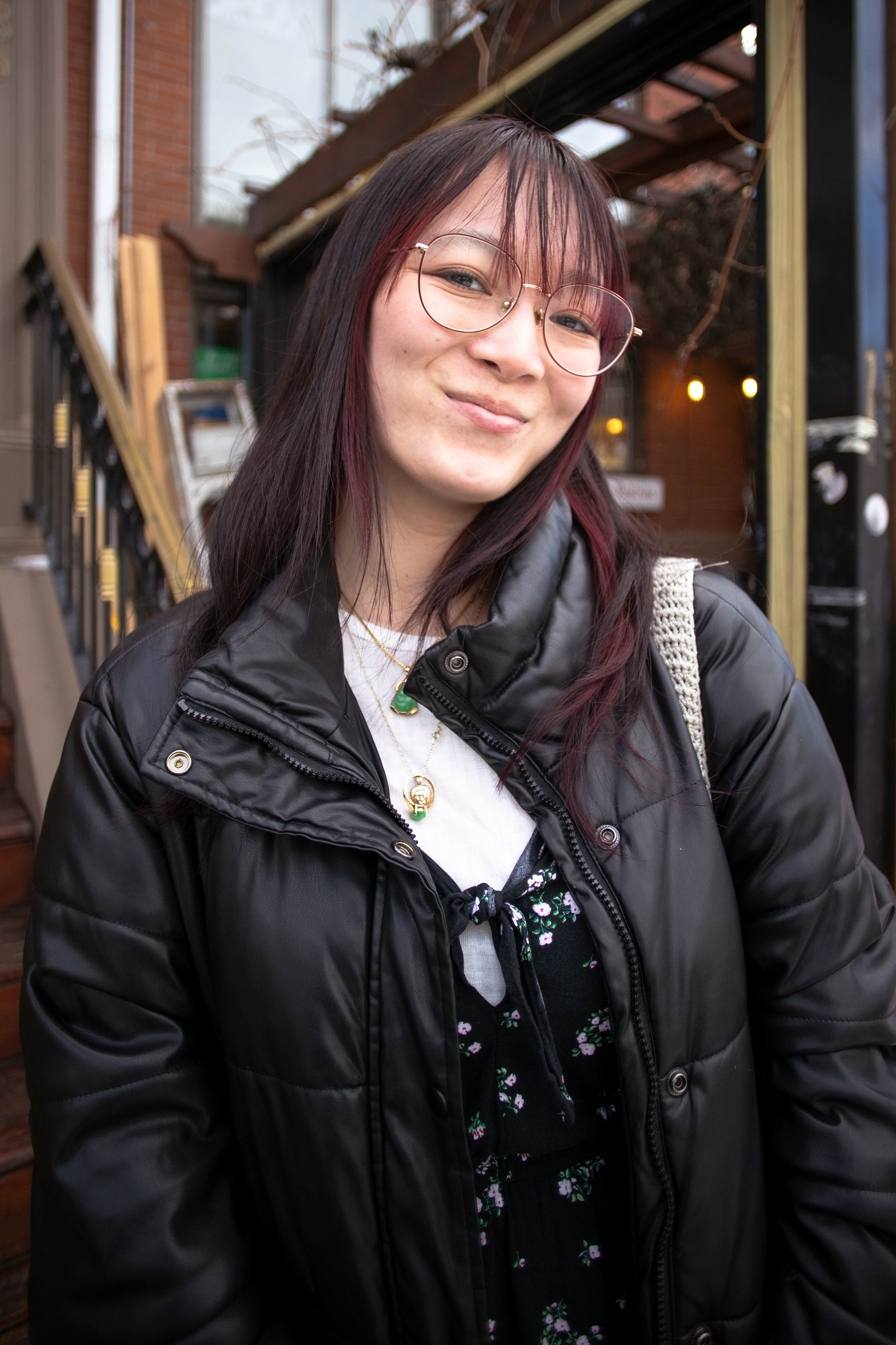 Corrine Davidson standing outside of the front entrance of Andala, a spot in Cambridge, MA she likes to frequent; March 1st, 2026.