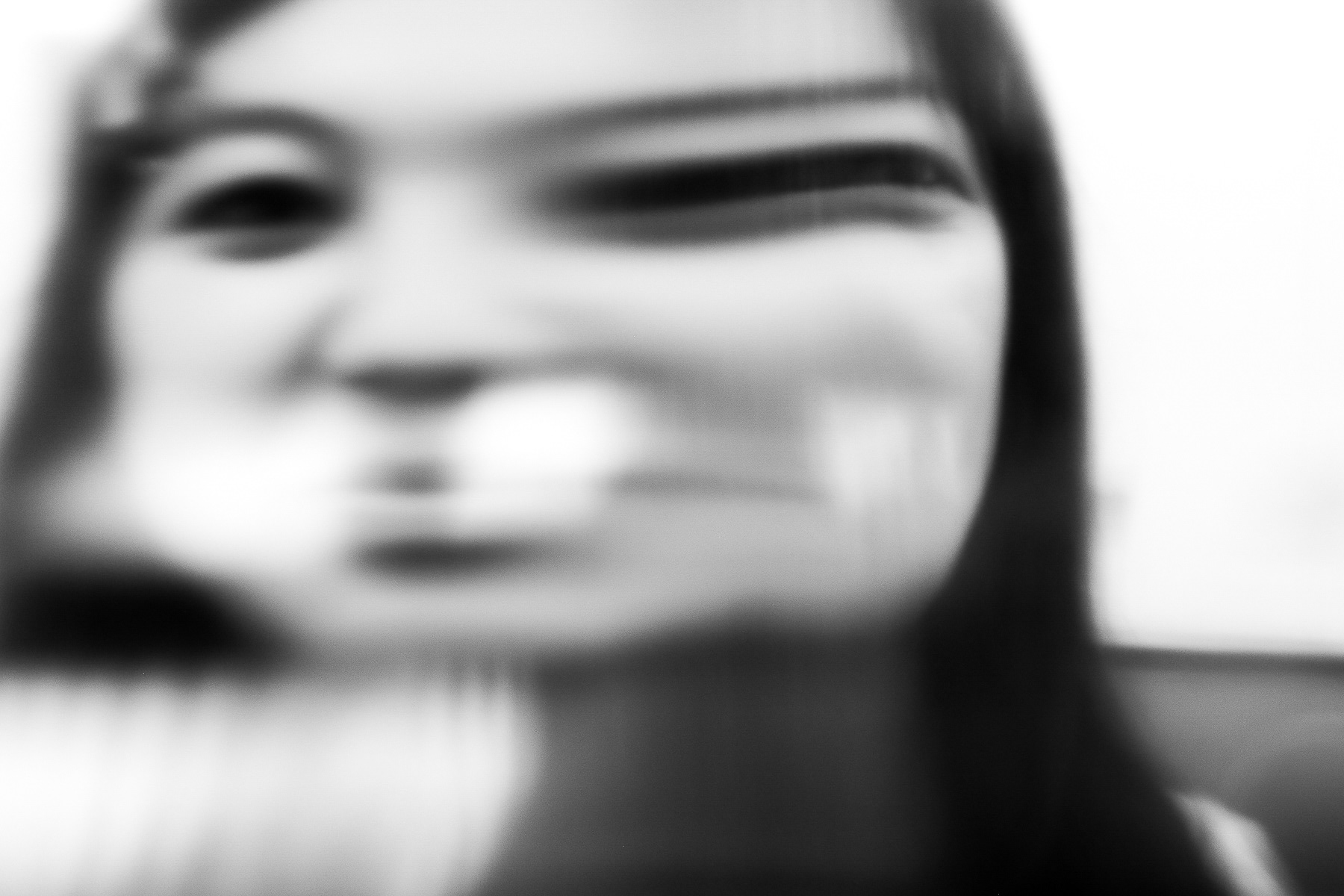 Distorted portrait of Sofia Innamorato taken through the glance of a large vodka bottle at Boston University's College of Fine Arts; February 4th, 2025.