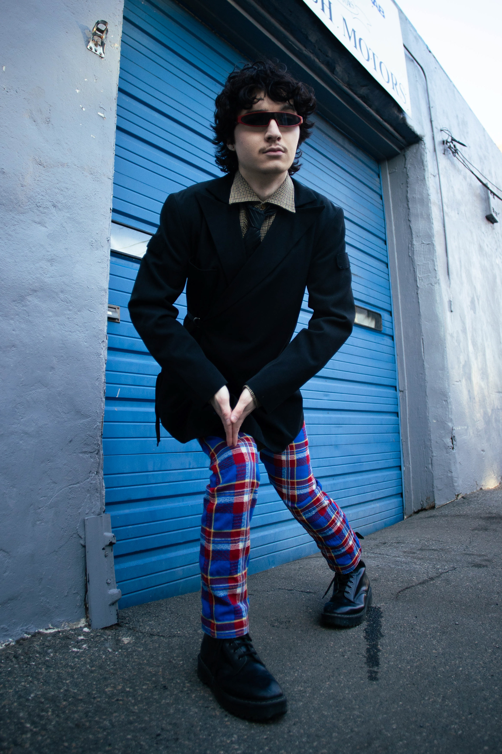 Ian Krockel struts a pose behind a Swedish motorshop in Allston, MA; February 28th, 2026.