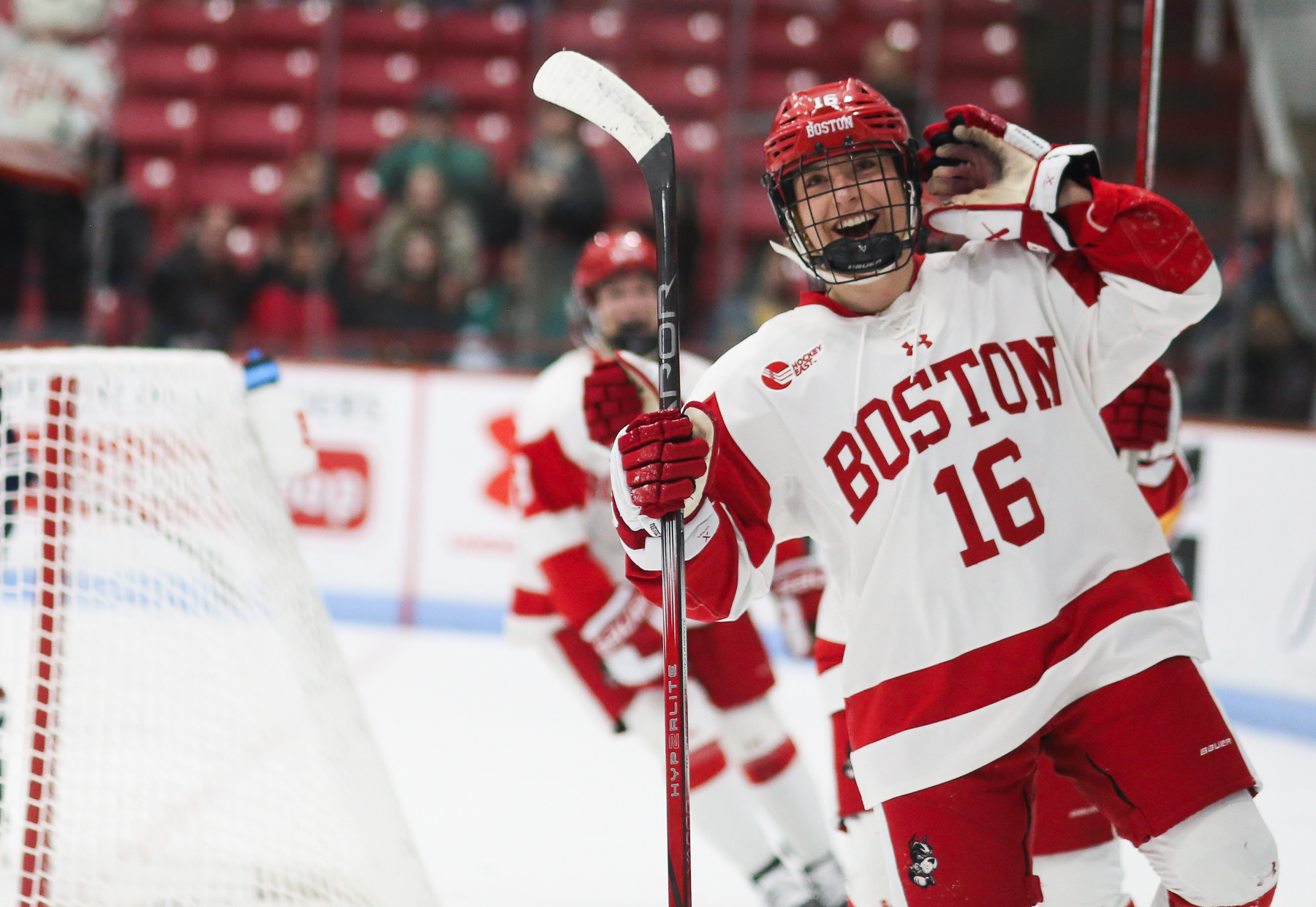 After the Boston University Women's Hockey team scored their first point in the second period, Kyla Josifovic (#16; BU) looks off to the distance of the crowd with a huge smile, and places her left hand on her ear to signal the crowd to get loud; February 22nd, 2025.