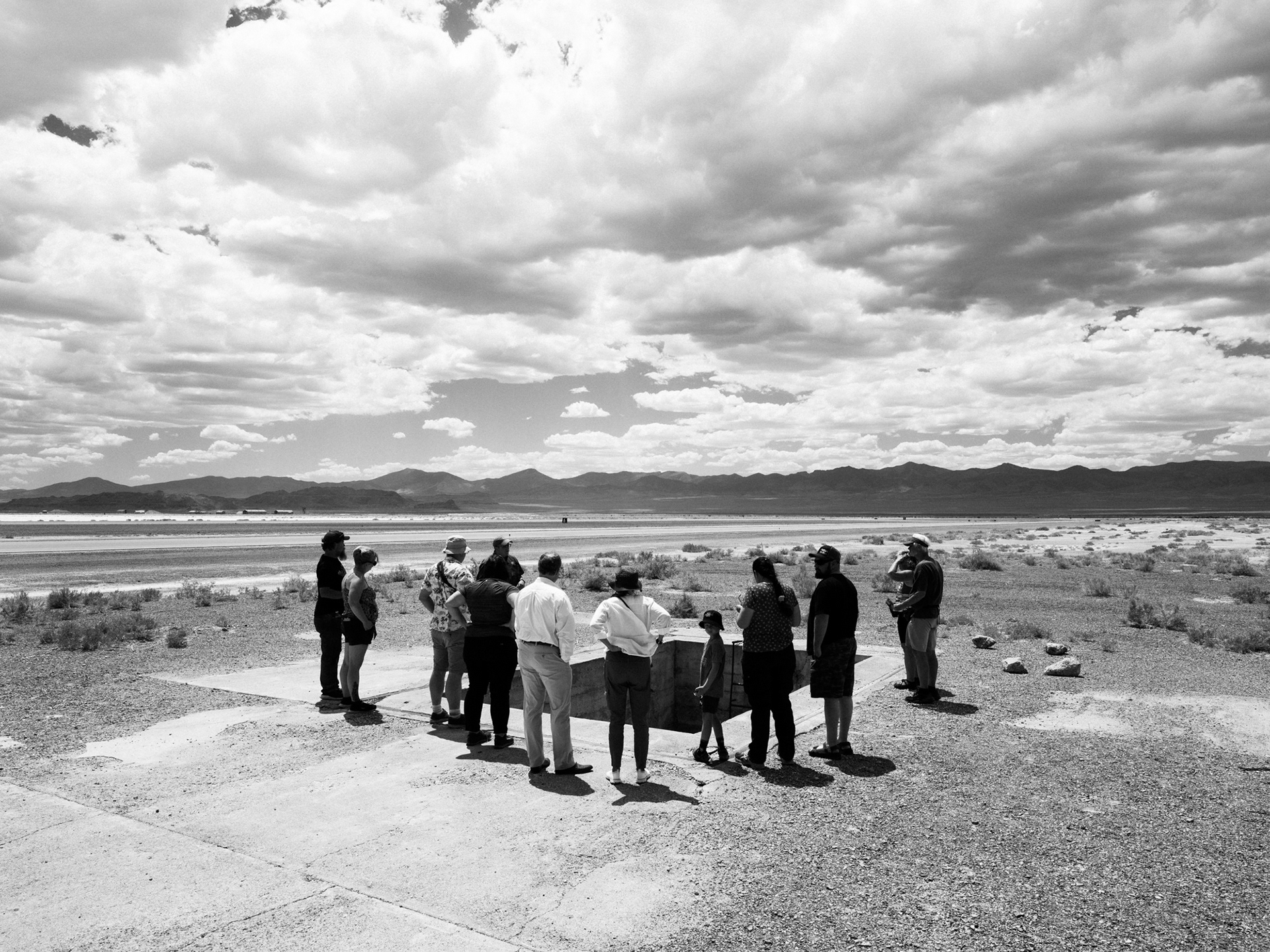 Tourists gather around bomb pit #1.