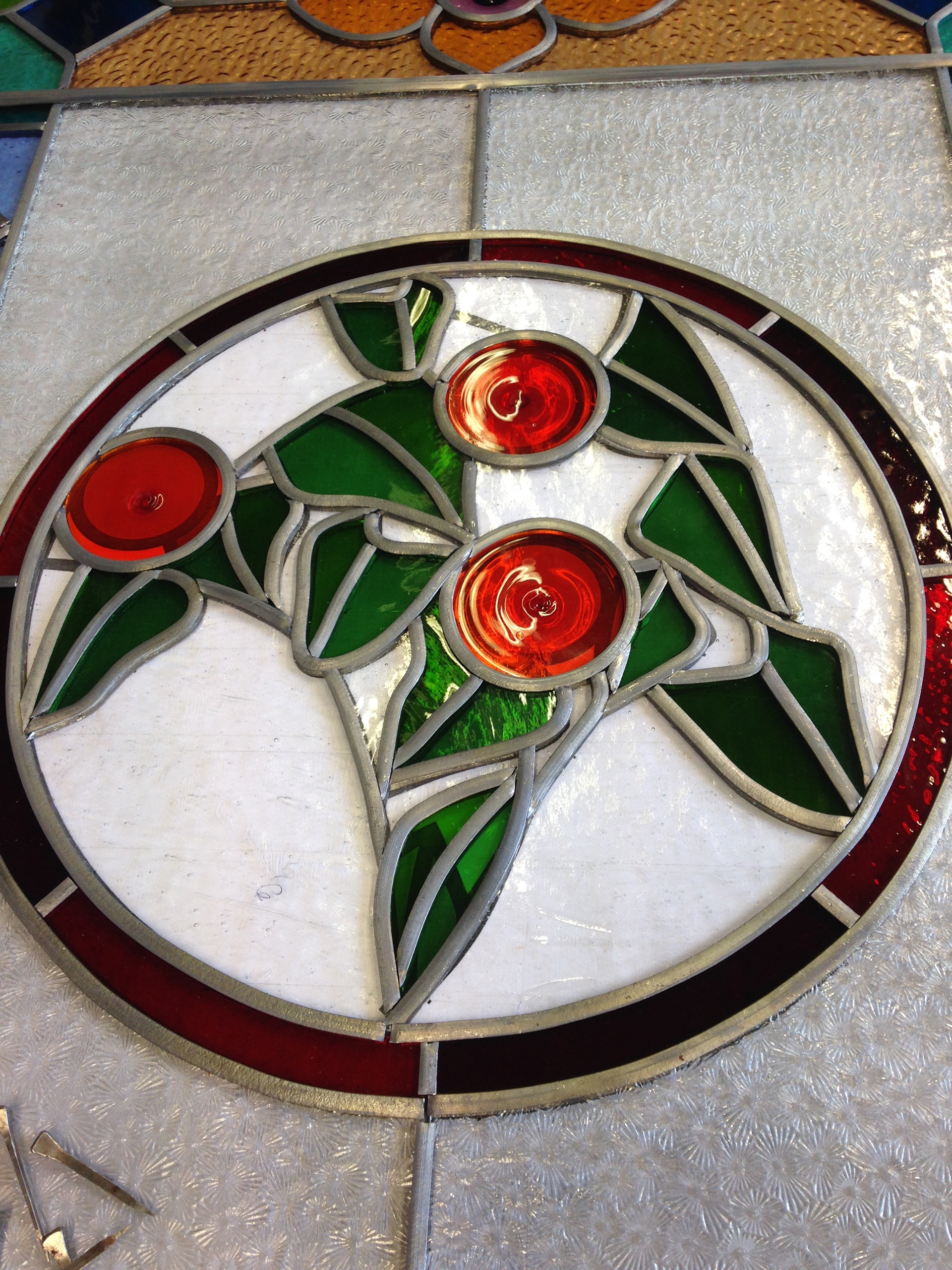 Stained glass victorian panel, Art glass commissioned piece comprising of traditional glass, lead, solder and cement. Made at the Glass Garden Leeds by Zoe Eady who specialises in Stained Glass and Art Glass. Central art section using handblown glass roundels and Spectrum Green Waterglass