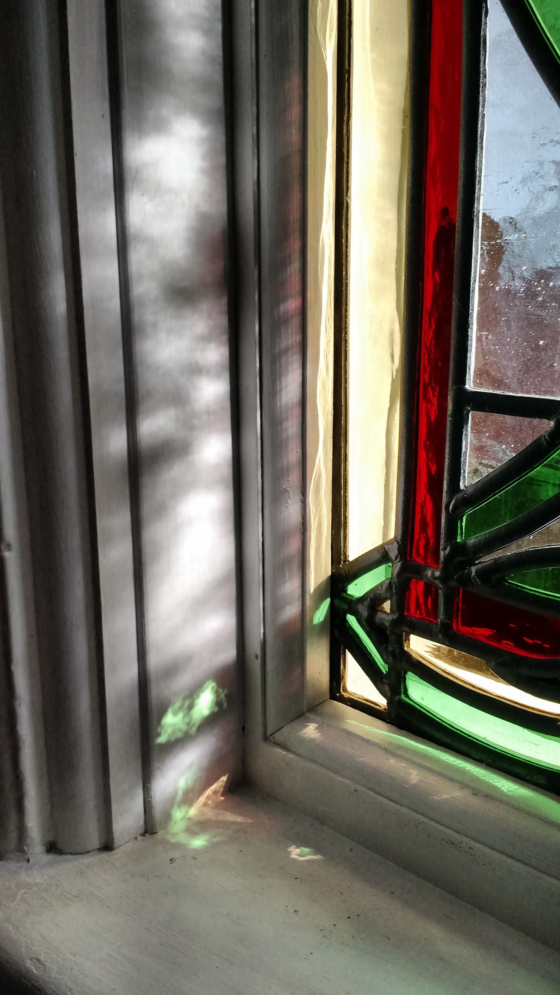 Traditional Stained glass leaded light original Art Nouveau theme by Zoe Eady of The Glass Garden. Lotus flower - close up showing light coming through the window and shining onto the framework