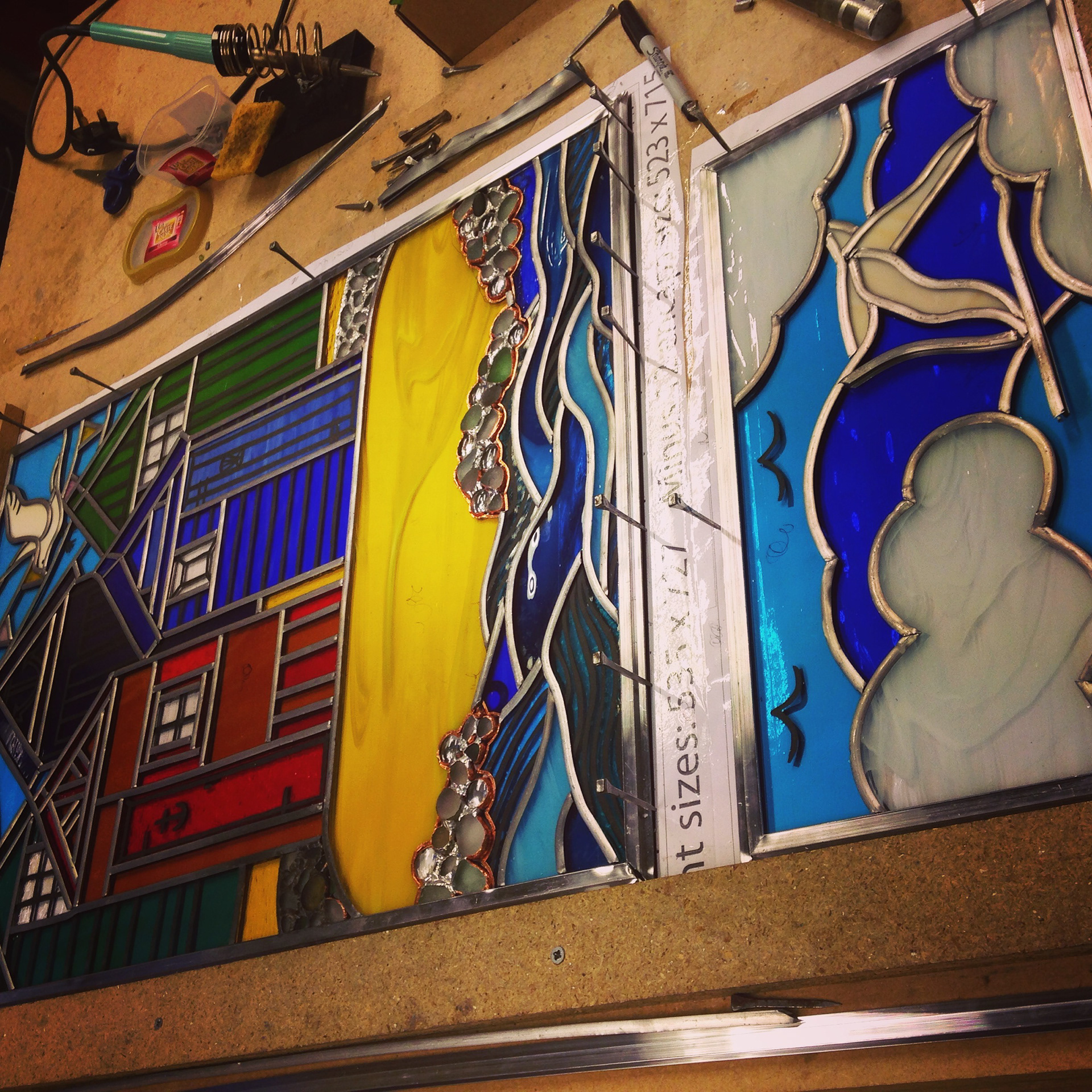 Stained Glass window for York featuring Beach Huts and genuine seaglass pebbles. Made by Zoe Eady of the Glass Garden - a Stained Glass Artist from Leeds UK.