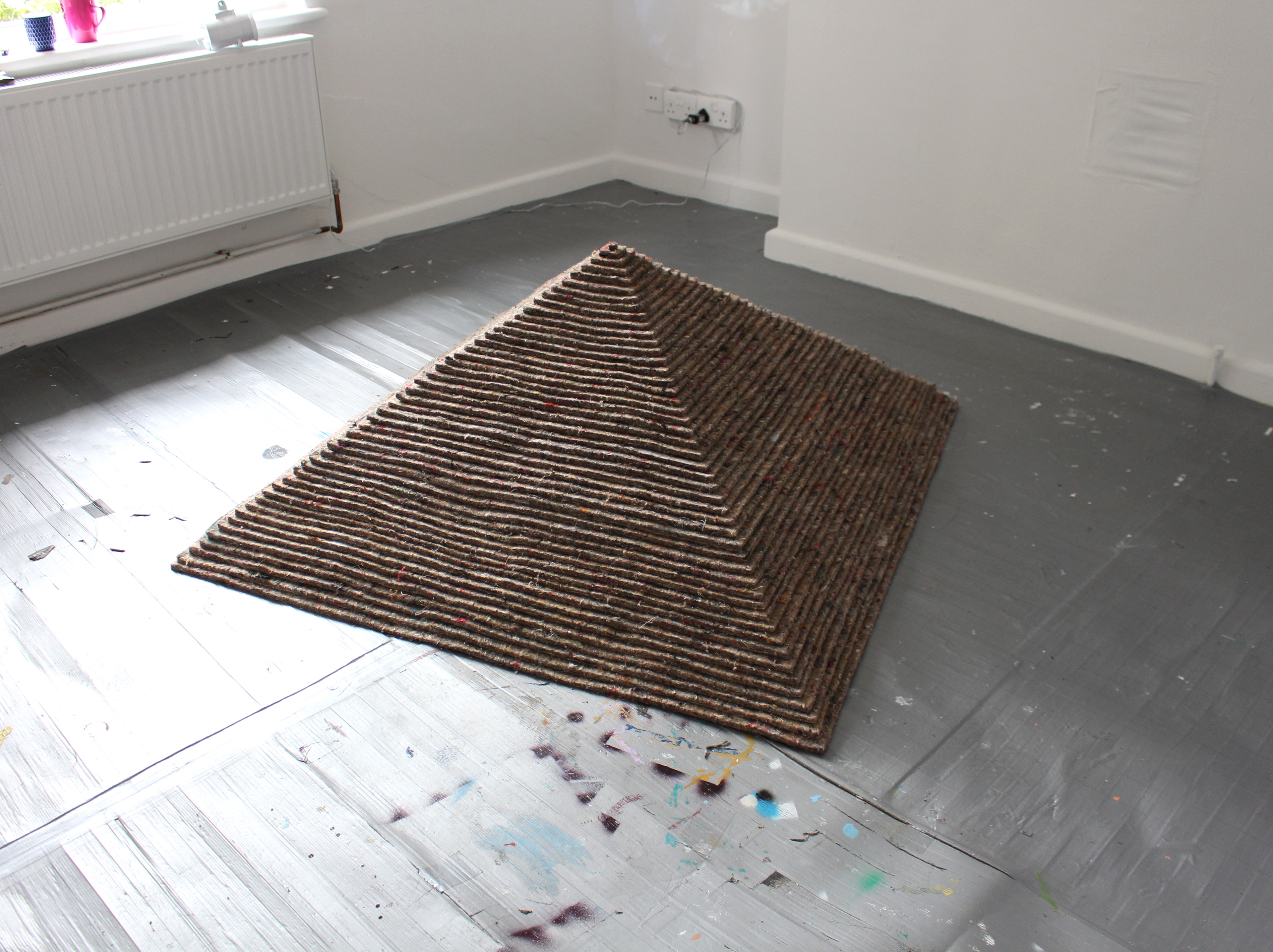 Galen Riley - "Elevated Underlay" - 2022 - Recycled fibre carpet underlay, pin - 118 x 118 x 59 cm
