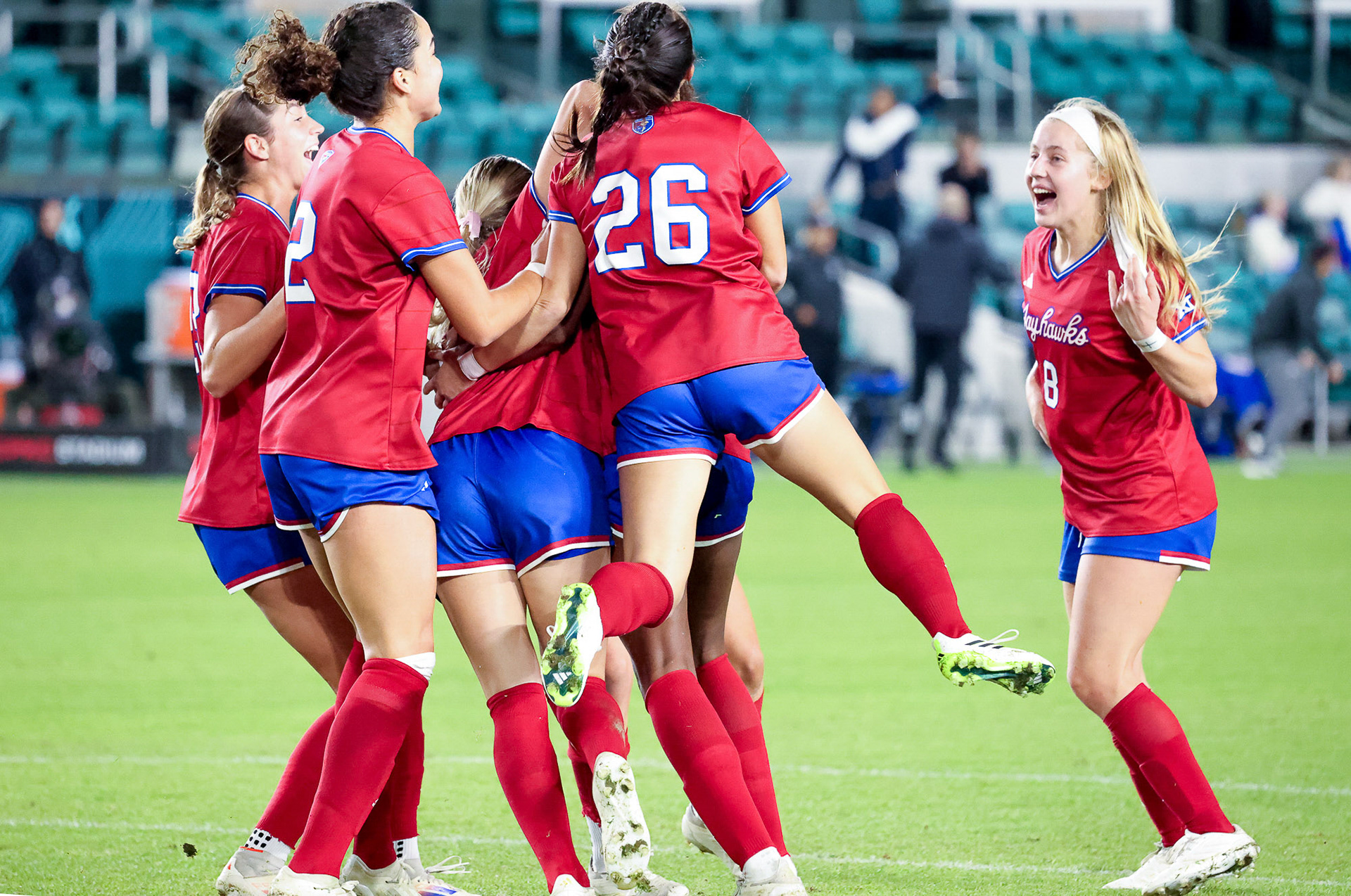 The KU women’s soccer team celebrates after a goal scored by senior Raena Knust at CPKC Stadium in Kansas City, Mo. on Wednesday, Nov. 6, 2024.