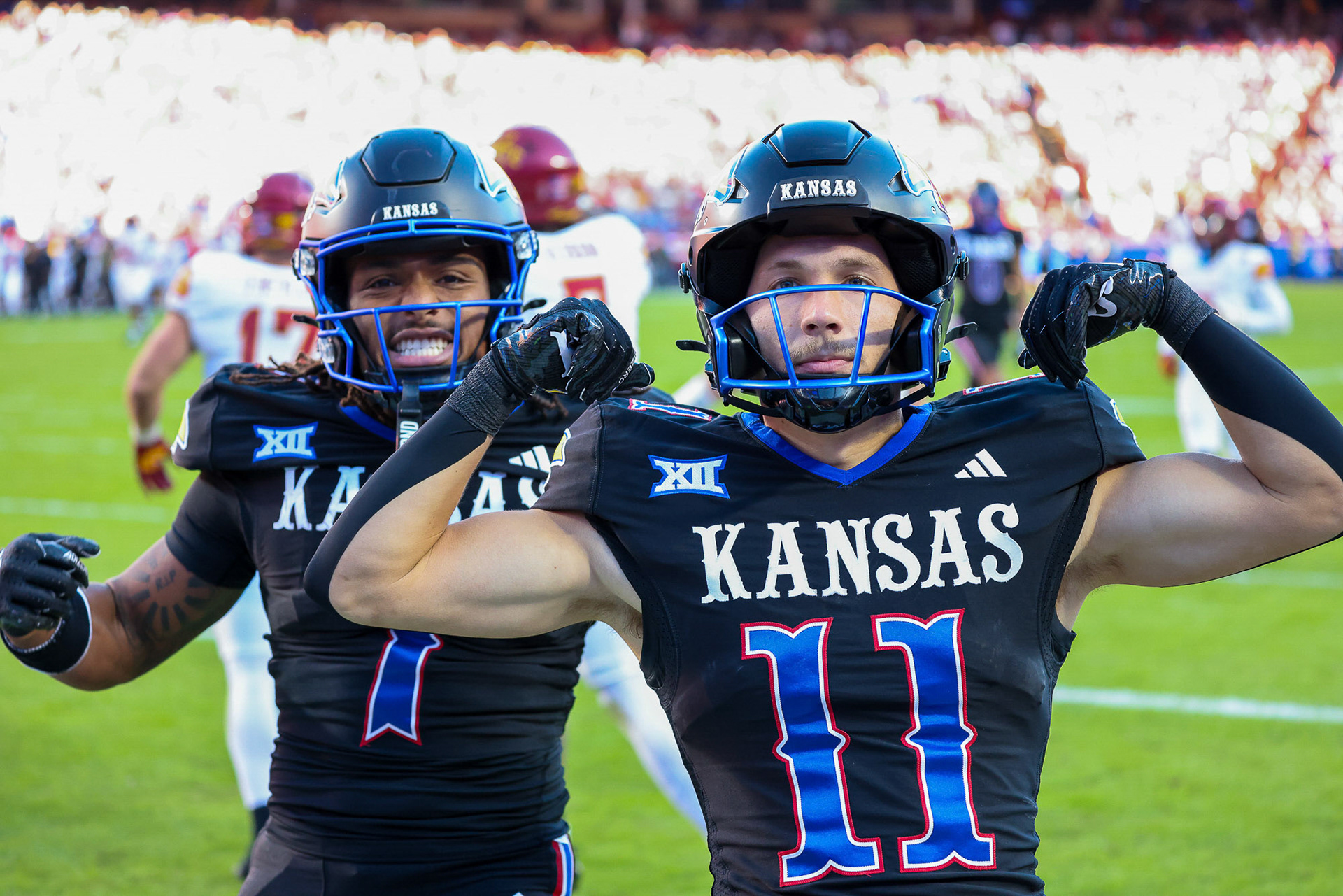 KU senior Luke Grimm flexes with teammate Trevor Wilson (left) after scoring a touchdown against Iowa State on Saturday, Nov. 9, 2024, at Arrowhead Stadium in Kansas City, Mo.