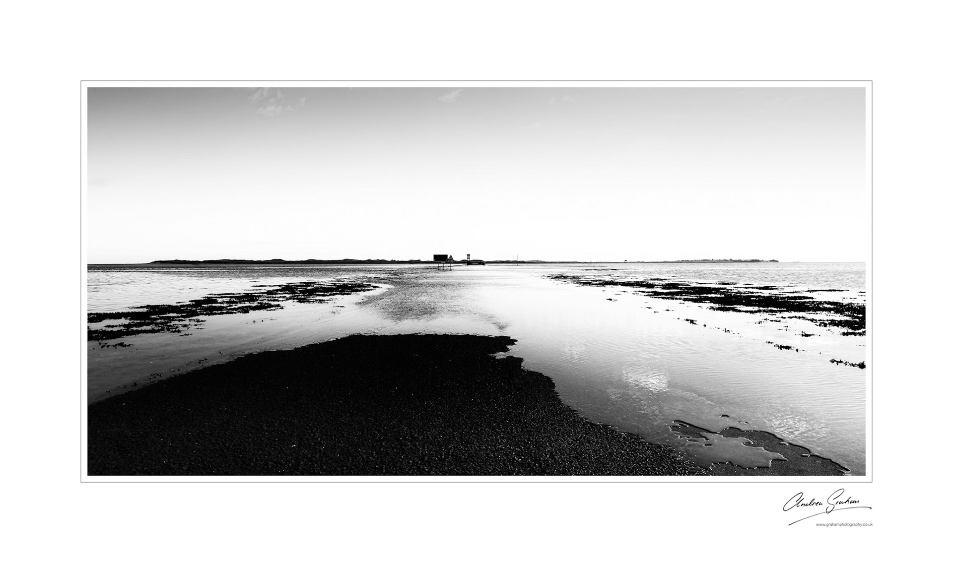 The relentless incoming tide across the tarmac of the Causeway - Lindisfarne