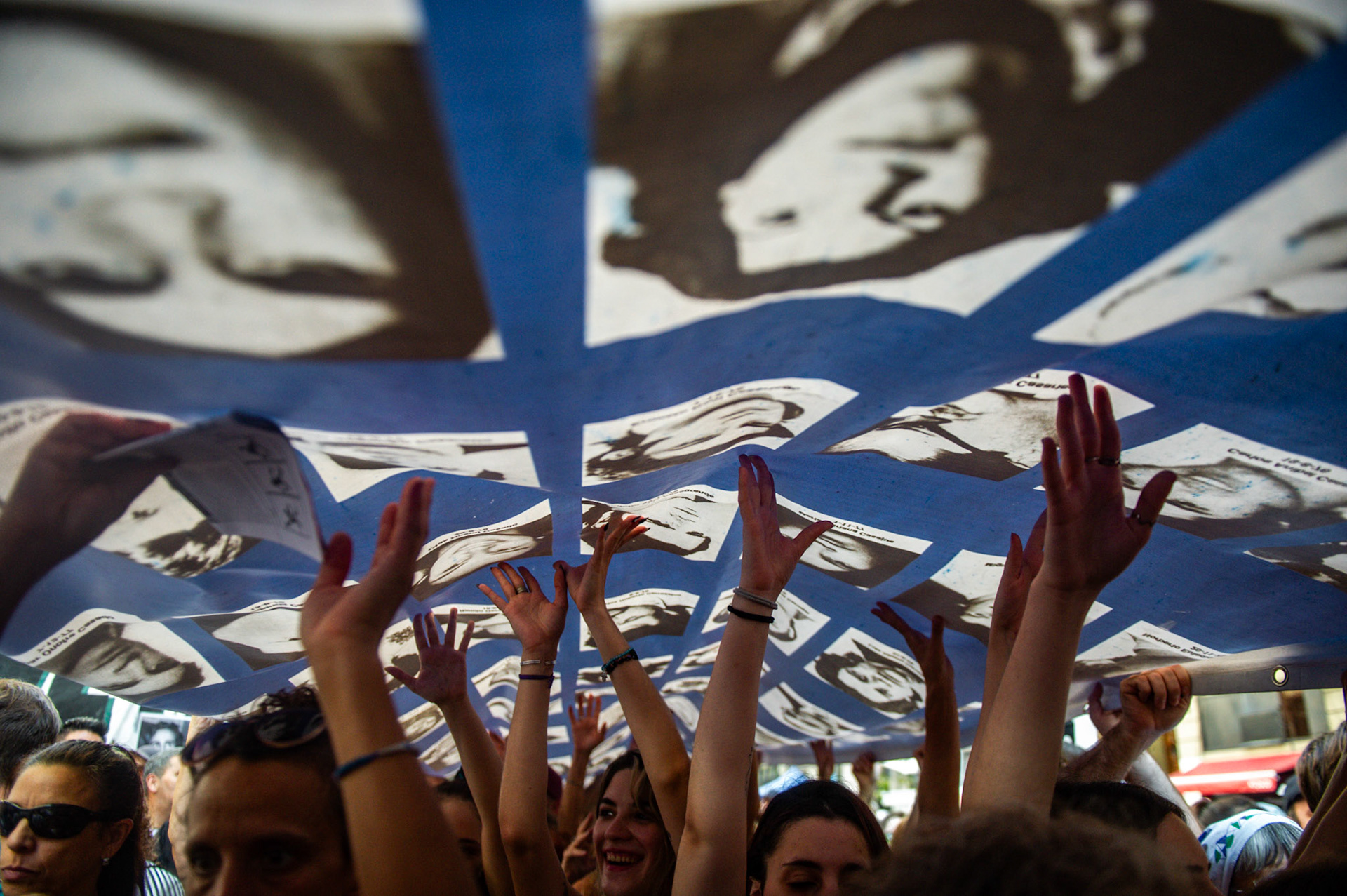 Participants carry a banner honoring the victims of Argentina’s military dictatorship during a “Memory” march | Buenos Aires, 2024.