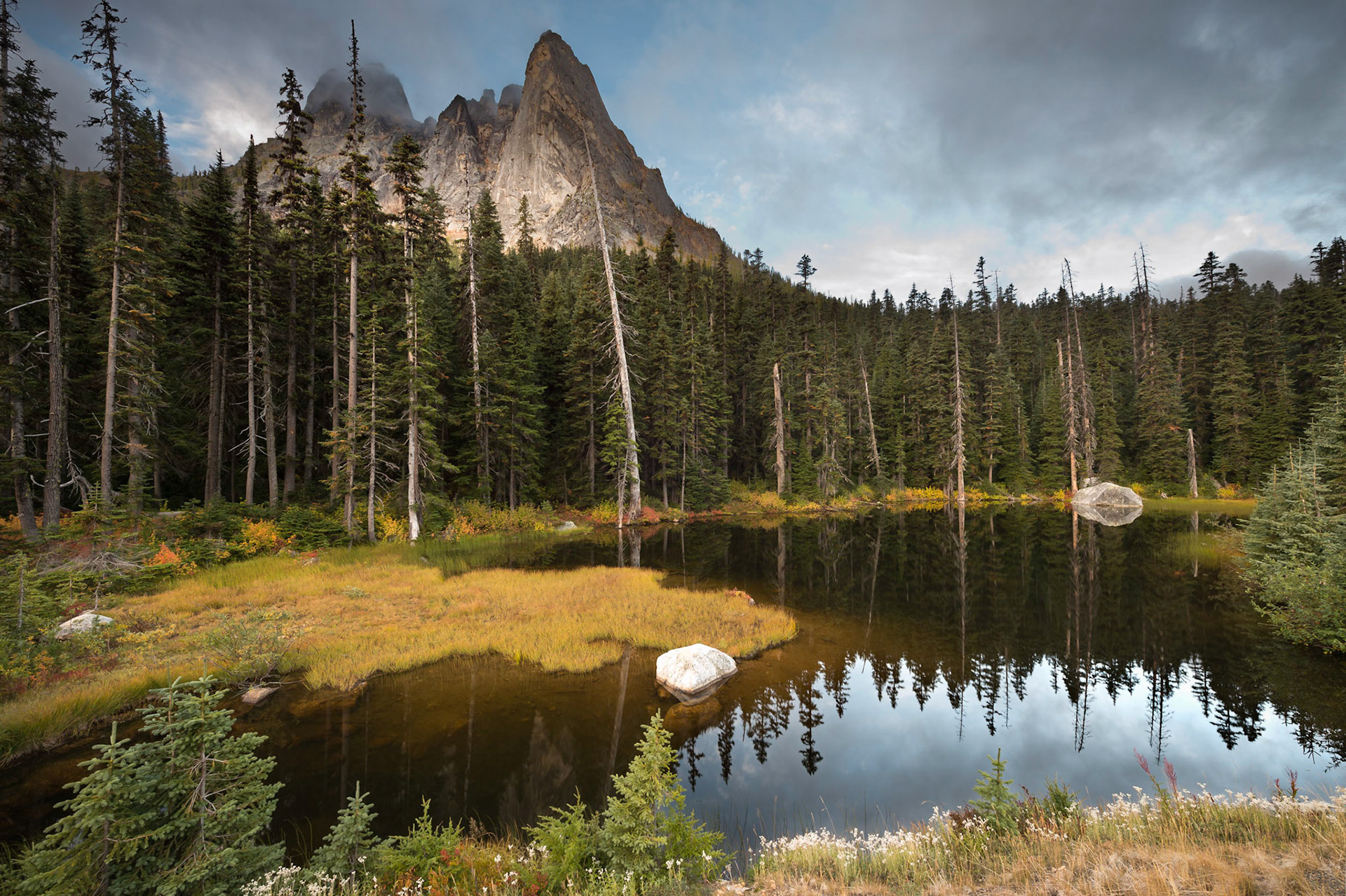 This well known tarn is located in the Northern Cascade mountain range (Cascade Pass) of Washington State.  At an elevation of around  5,700 ft. there is still no  snow so far this year but I thought the autumn colors with Liberty Bell mountain in the background made for a nice composition anyway.    Thank you for viewing, voting and/or any constructive comments!