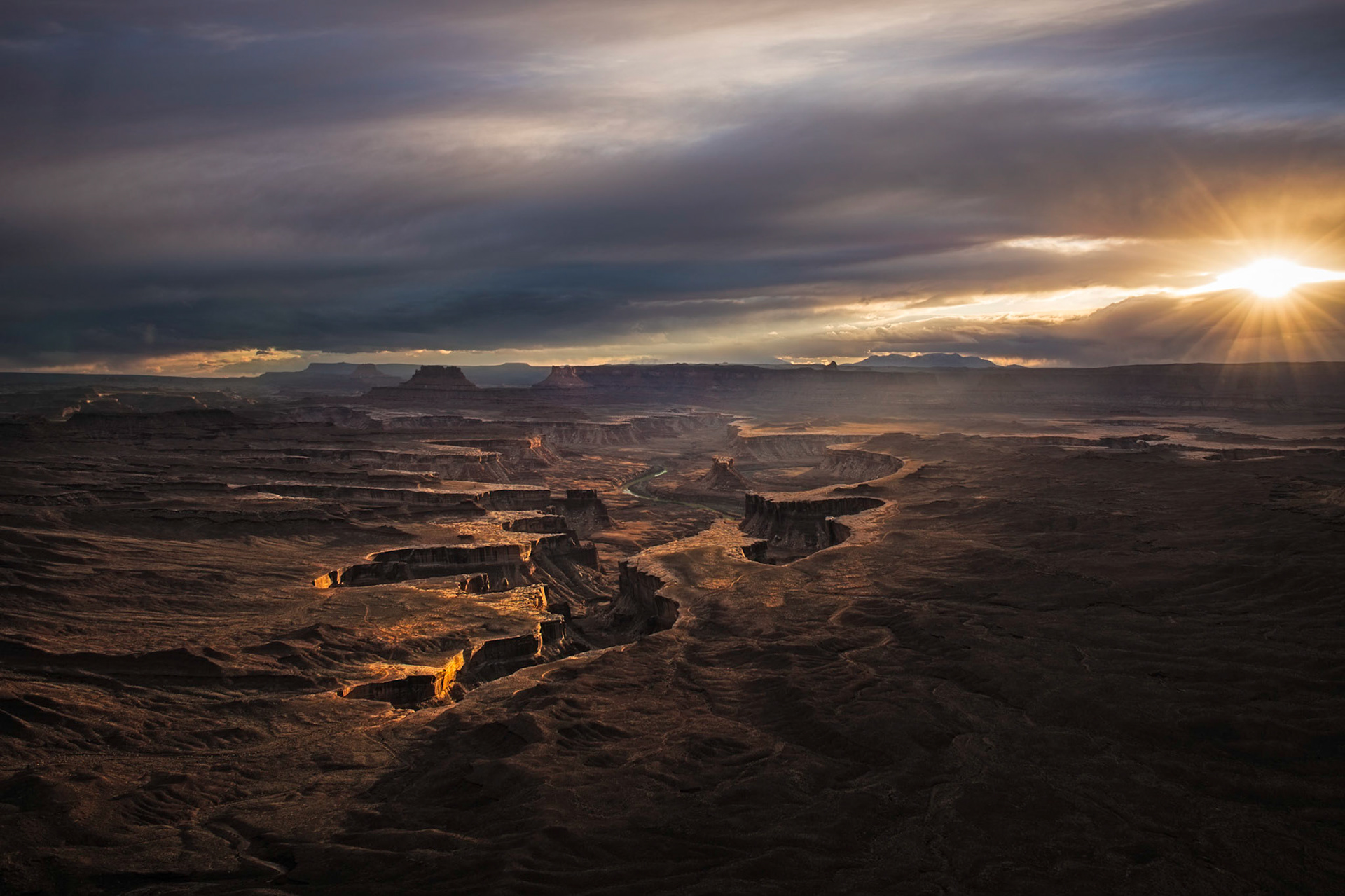 Things didn't look too promising weatherwise when we first arrived at the Green River Overlook area for an evening sunset shoot. About an hour before this shot was taken things were totally socked in and it was snowing (lightly but steadily). Just as we were about to give up the snow suddenly stopped falling and we started to see a few breaks in the  sky/clouds with some beautiful light rays raking acrooss the canyon floor..this is the result.   Thank you for viewing, voting and/or any constructive comments!