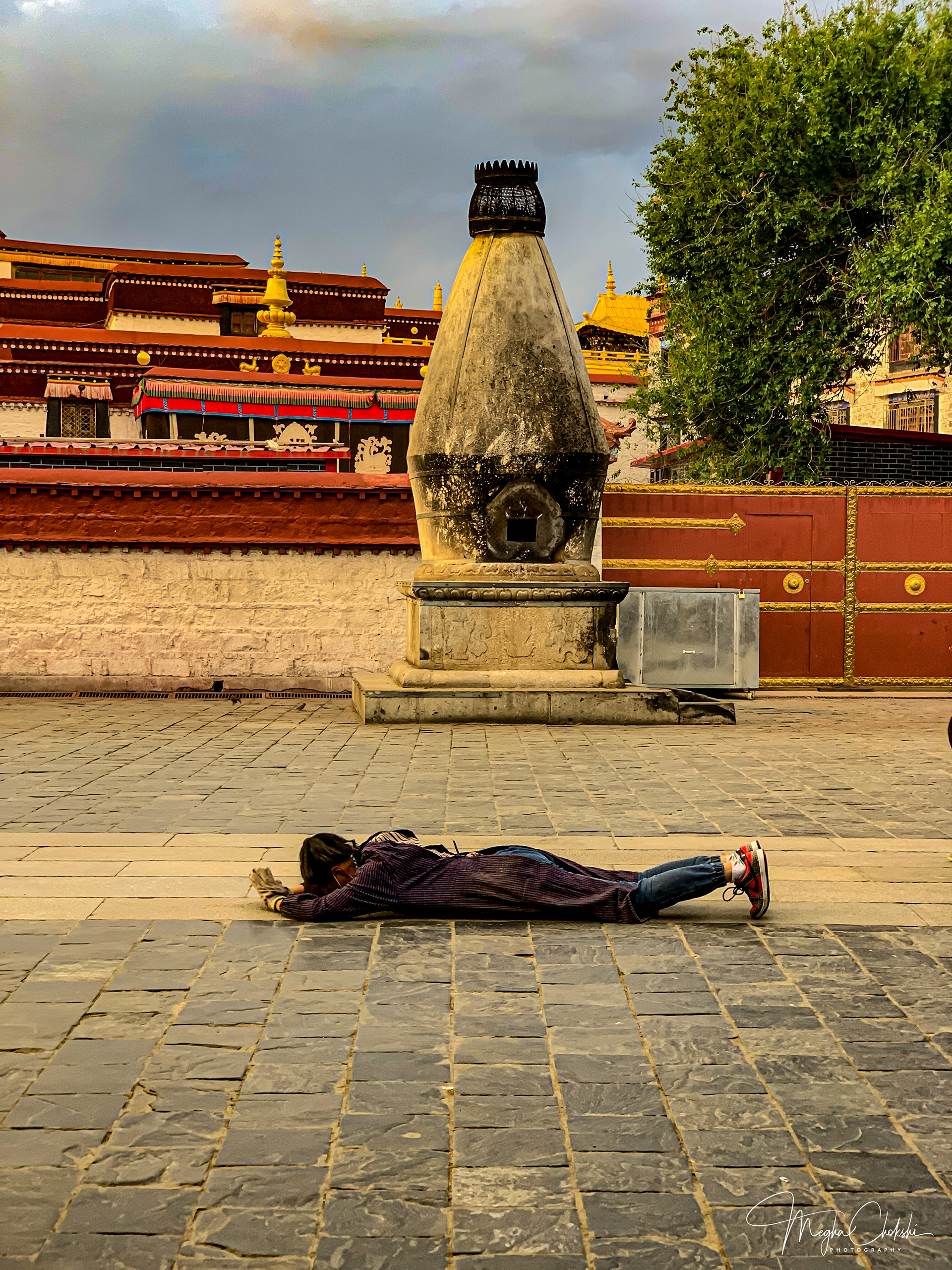 Prostrating pilgrim performing the circumambulation of Jokhang Temple