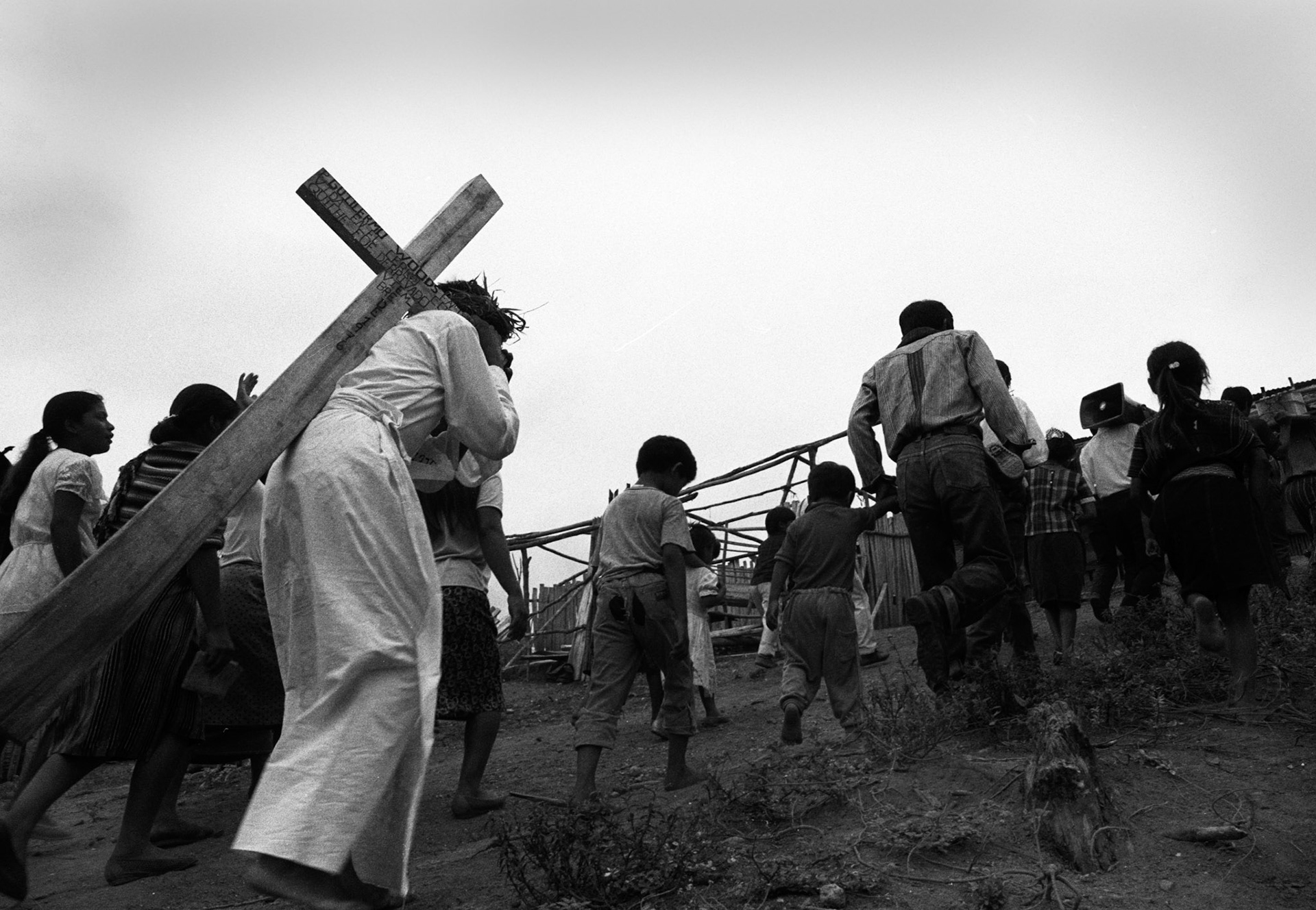 Stock image of Easter Procession in Cuarto Pueblo, Ixcan Jungle, Guatemala with a cross inscribed with Guillermo Woods on it- the Catholic priest who helped get the Mayans from the highlands this land in the jungle. He was killed by the Guatemalan military.