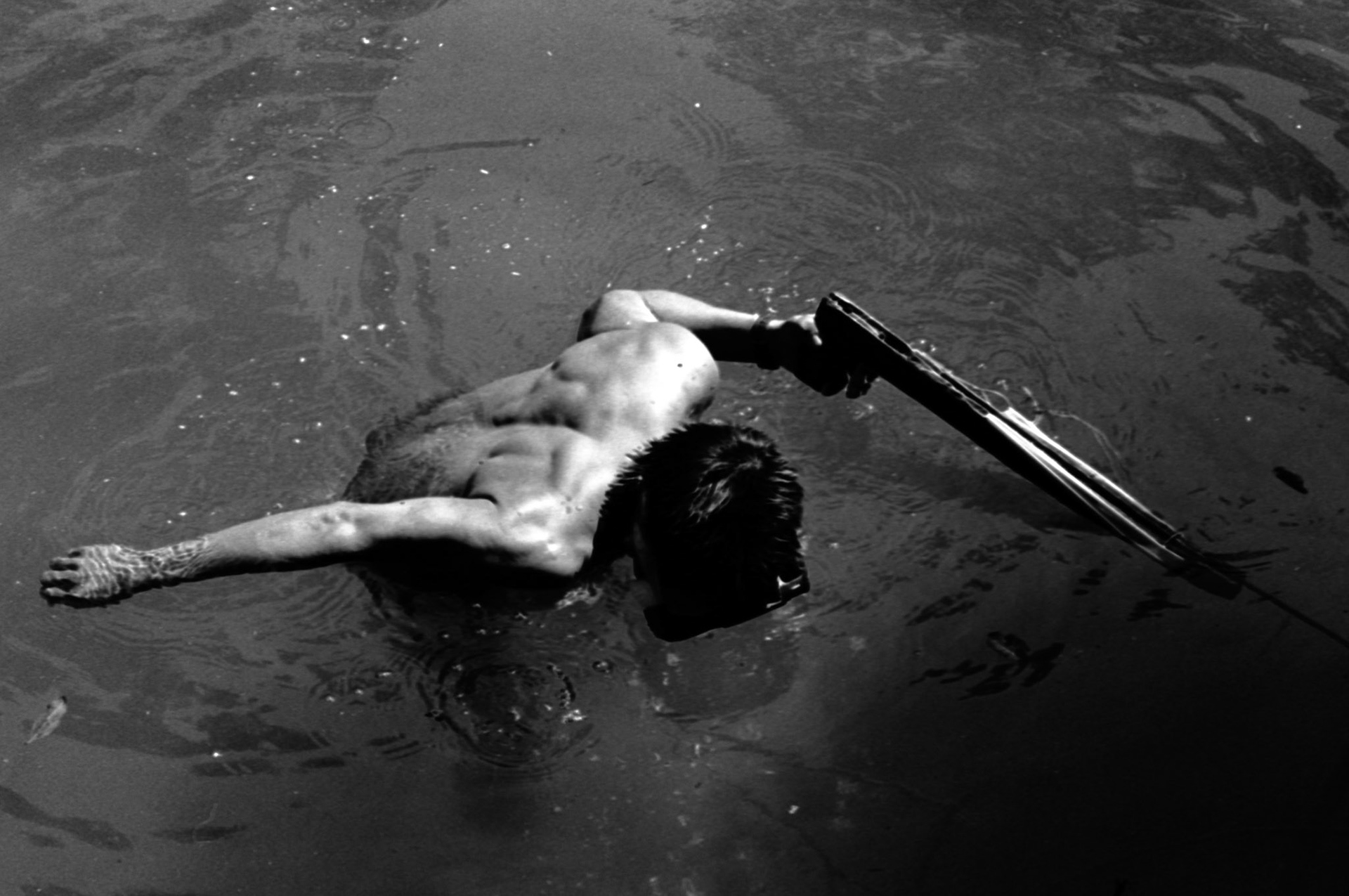 Stock image of a Mayan man spearfishing in a jungle river in the ixcan of Guatemala