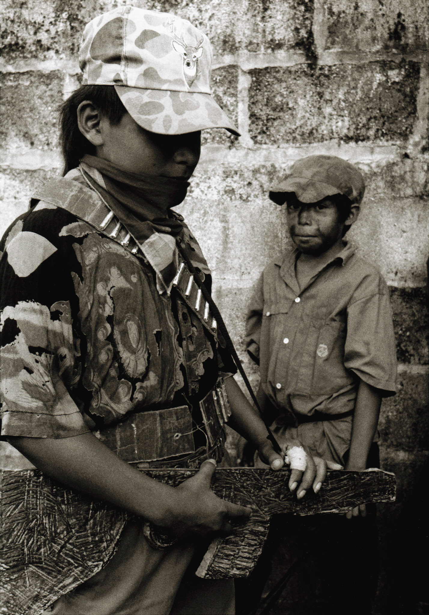 young mayan children in the Ixcan Jungle dressed up like guerrillas to act in a re-enactment of the 1982 massacre of 374 people in Cuarto Pueblo during the Guatemalan Civil War.